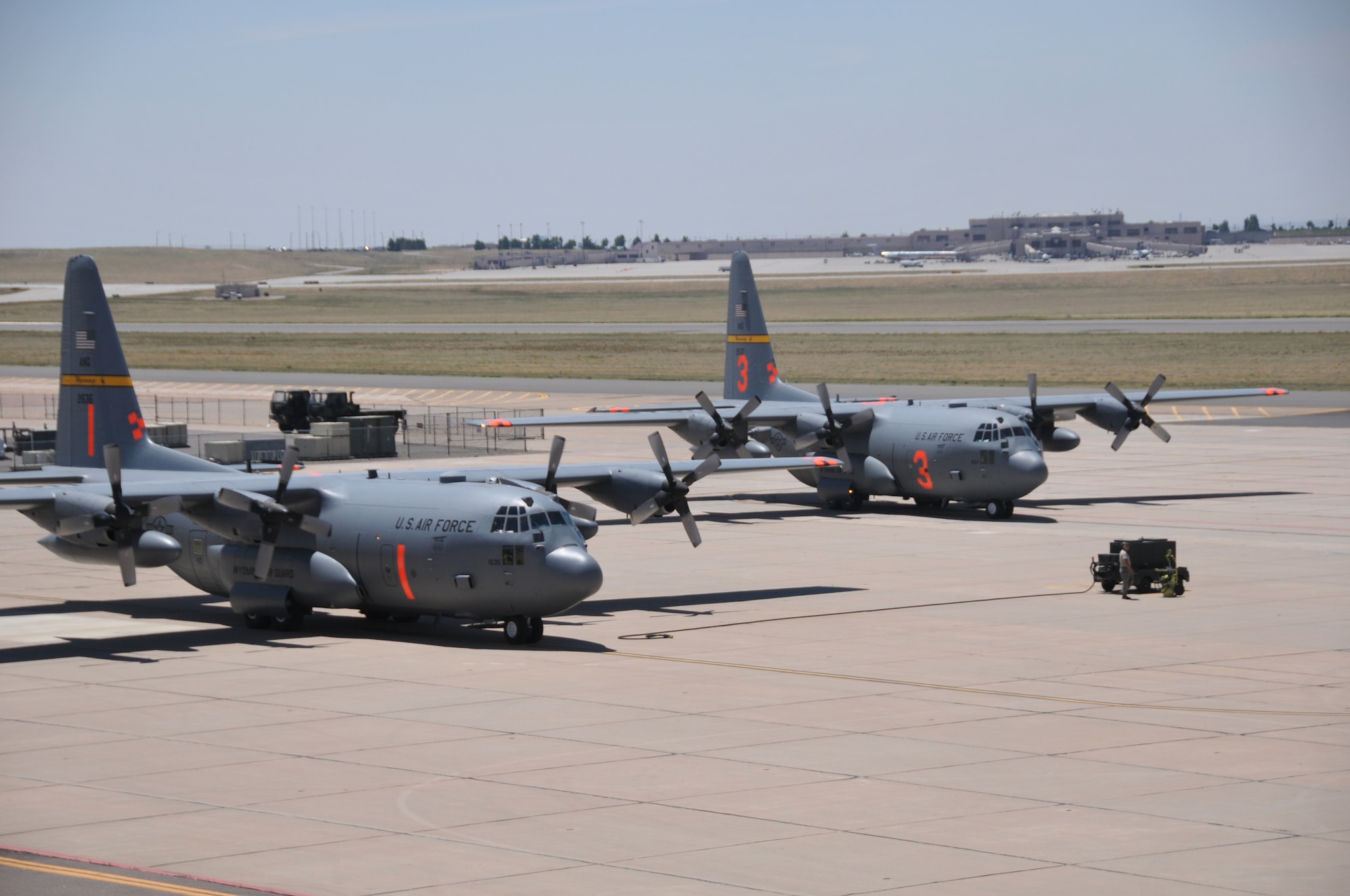 Airmen and MAFFS-equipped C-130s assigned to the 153rd Airlift Wing, Cheyenne, Wyo., arrive at Peterson Air Force Base, Colo., to provide support to ongoing Colorado firefighting efforts. The 153rd Airlift Wing, along with the 302nd Airlift Wing, have been tasked to provide the requested MAFFS support in the state. (U.S. Air Force photo/Airman 1st Class Nichole Grady)