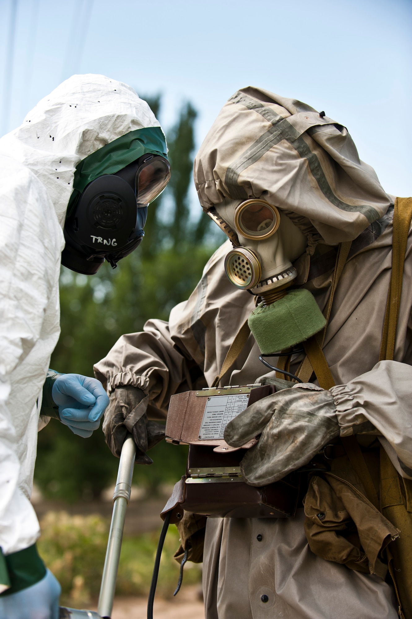Master Sgt. Michael English(left) and Kyrgyz Republic Sgt. Nuvlau Imanbekov assess the readings of simulated contaminated materials as part of a chemical biological, radiological, nuclear, and explosives training scenario during Exercise Regional Cooperation 12 at the Koi Tash Military Academy, June 22, 2012. Service members from the Transit Center at Manas participated in the exercise to help strengthen relationships and cooperation of attending nations. Regional Cooperation 12 is a multi-national exercise designed to strengthen relationships and promote regional cooperation among the participating nations while offering coordinated, rapid response scenarios in the event of a disaster affecting multiple countries within the region. English is a 376th Expeditionary Civil Engineer Squadron emergency management flight chief deployed out of Fairchild Air Force Base, Wash. and is a native of Washington, Ga. (U.S. Air Force photo/Senior Airman Brett Clashman)