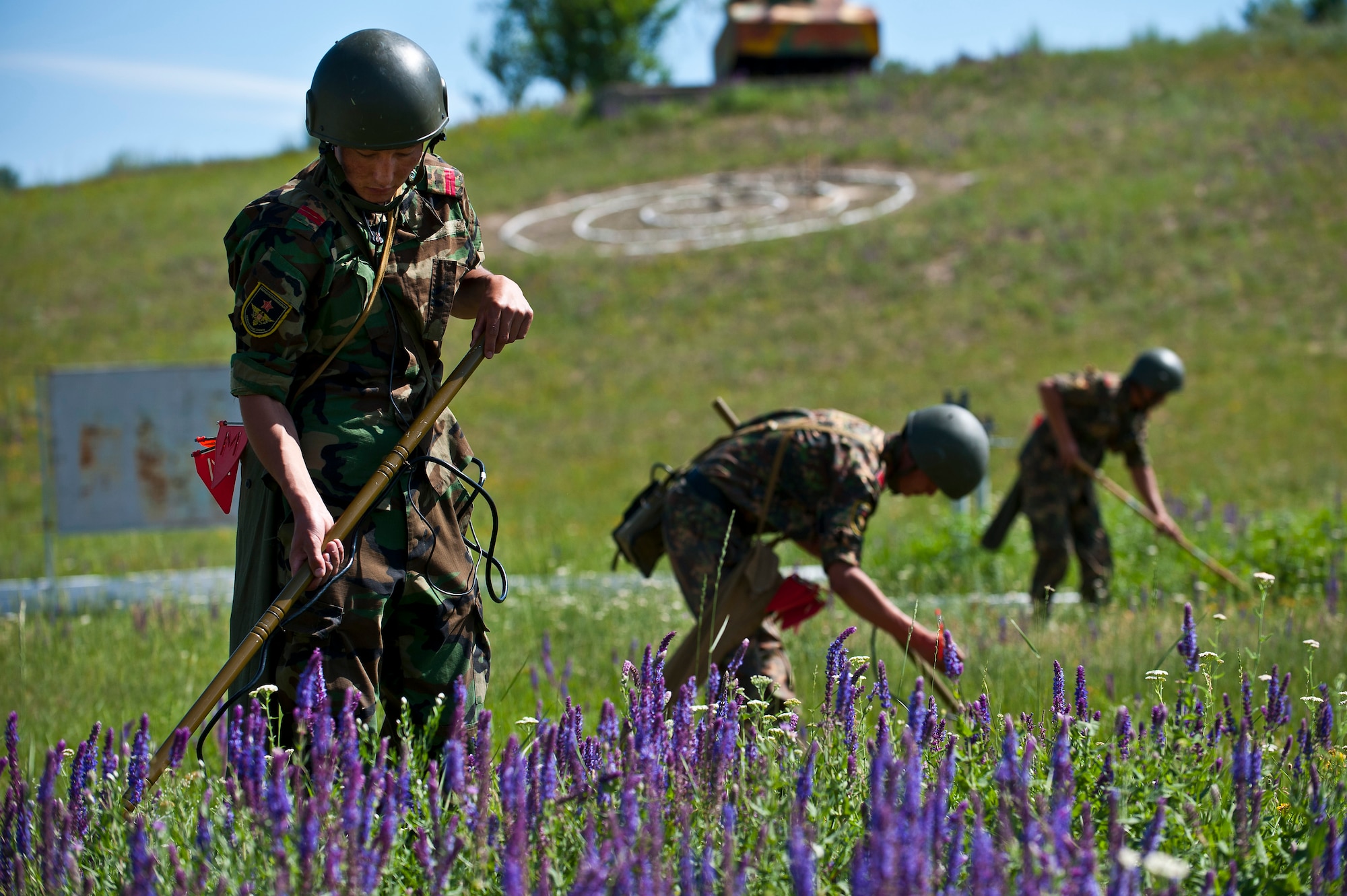 Kyrgyz Republic Cpl. Azamat Kemirkov sweeps for simulated landmines during Exercise Regional Cooperation 12 at the Koi Tash Military Academy, Kyrgyzstan, June 22, 2012. Regional Cooperation 12 is a multinational exercise designed to strengthen relationships and promote regional cooperation among the participating nations while offering coordinated, rapid response scenarios in the event of a disaster affecting multiple countries within the region. (U.S. Air Force photo/Senior Airman Brett Clashman)