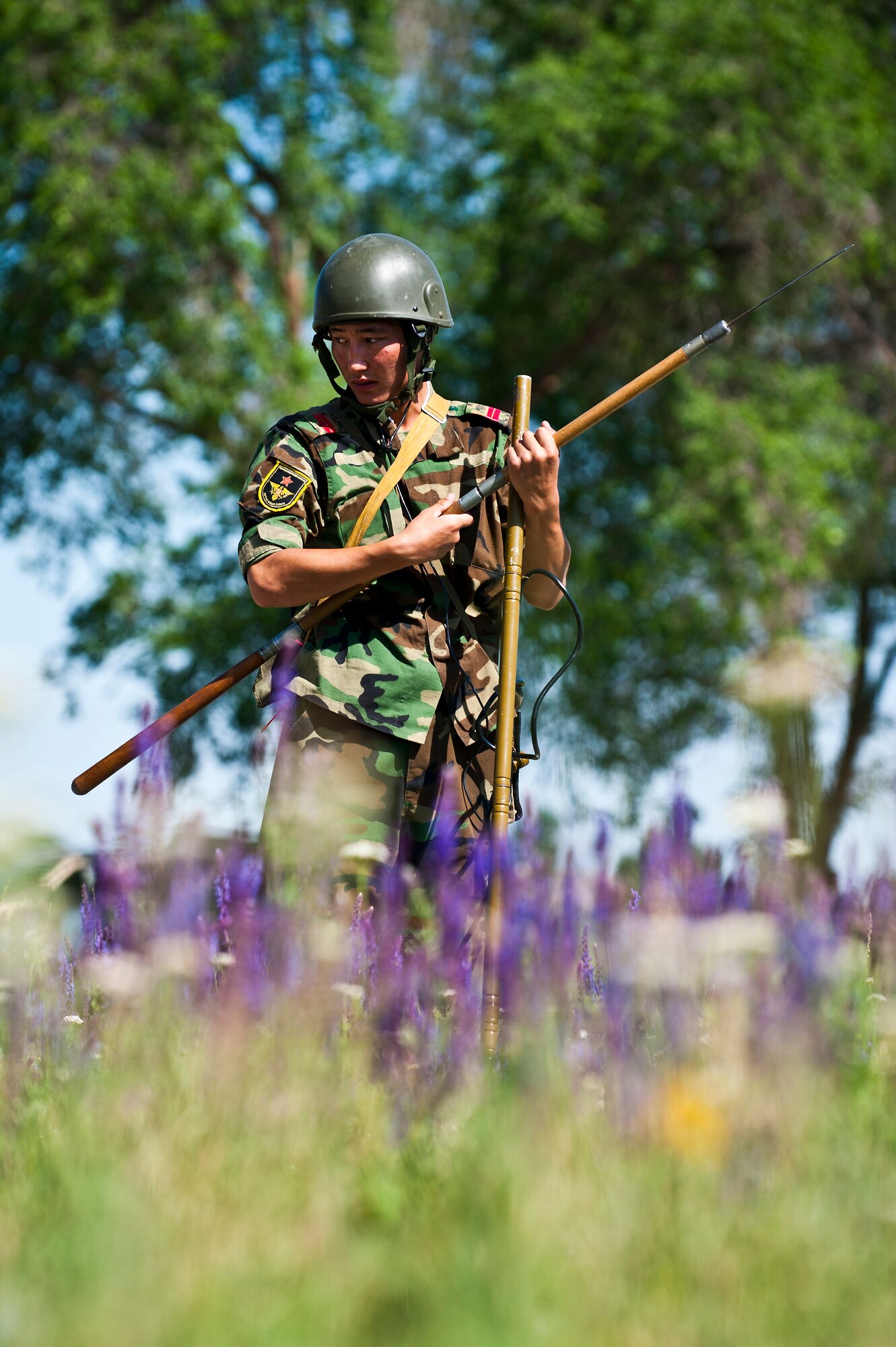 Kyrgyz Republic Cpl. Azamat Kemirkov assesses a field for simulated landmines during Exercise Regional Cooperation 12 at the Koi Tash Military Academy, Kyrgyzstan, June 22, 2012. Kyrgyz Republic and partner nations conduct Explosive Ordnance Disposal training scenarios throughout the exercise. Regional Cooperation 12 is a multinational exercise designed to strengthen relationships and promote regional cooperation among the participating nations while offering coordinated, rapid response scenarios in the event of a disaster affecting multiple countries within the region. (U.S. Air Force photo/Senior Airman Brett Clashman)