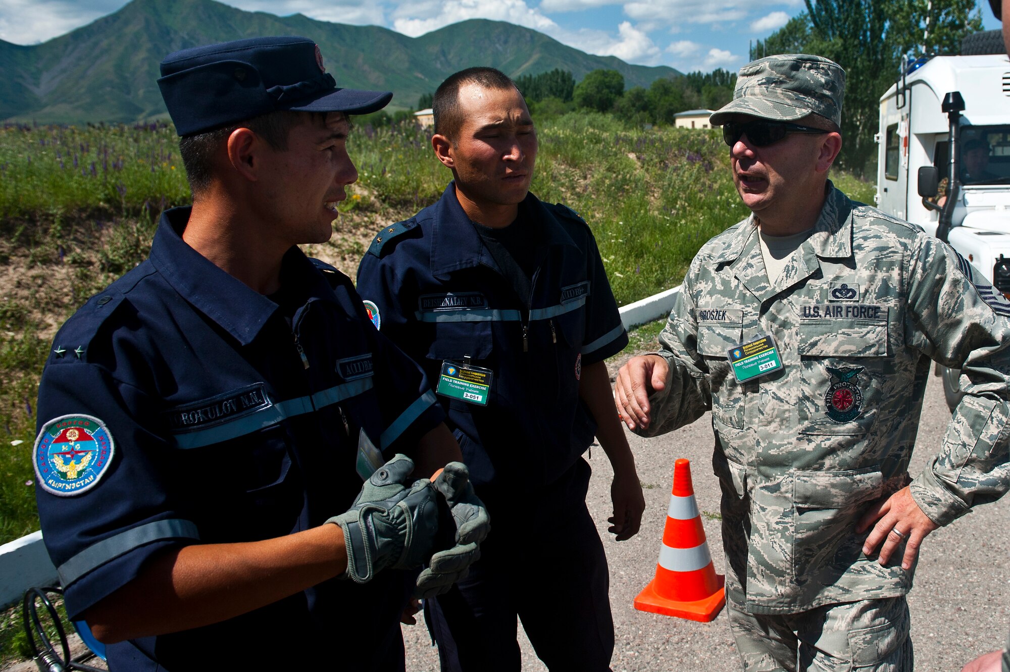 Chief Master Sgt. Stephen Groszek exchanges information with Kyrgyz Republic Ministry of Emergency Situation members Sgt. Venok Turokulov and Cpl. Nuvlikov Beishaneliev during Exercise Regional Cooperation 12, at the Koi Tash Military Academy, Kyrgyzstan, June 22, 2012. The 376th Expeditionary Civil Engineer Squadron emergency management flight and the Ministry of Emergency Situations partnered to take part in hands-on training during the exercise. Regional Cooperation 12 is a multinational exercise designed to strengthen relationships and promote regional cooperation among the participating nations while offering coordinated, rapid response scenarios in the event of a disaster affecting multiple countries within the region. Groszek is the 376 ECES fire chief deployed out of Grissom Air Force Base, Ind. and is a native of Chicago. (U.S. Air Force photo/Senior Airman Brett Clashman)