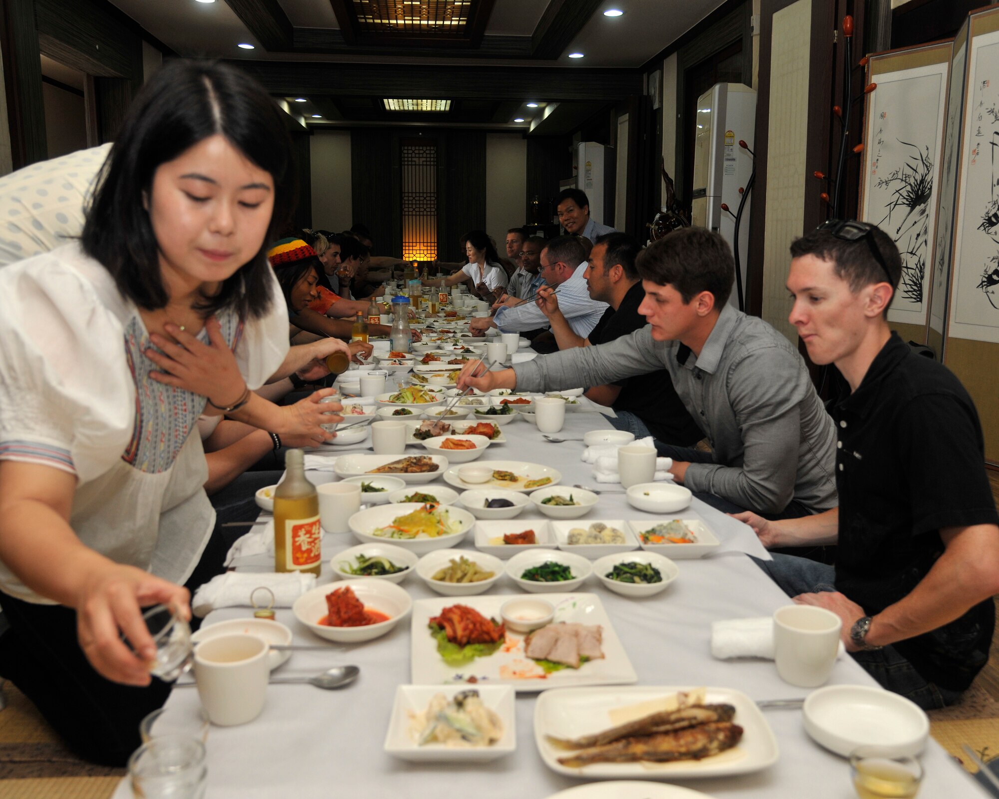 Attendees at the Gunsan City Cultural Tour are treated to a traditional Korean meal in Gunsan, Republic of Korea, June 20, 2012. The restaurant was chosen to showcase South Korea's rich culture and tastefully prepared dishes. (U.S. Air Force photo/Senior Airman Marcus Morris)
