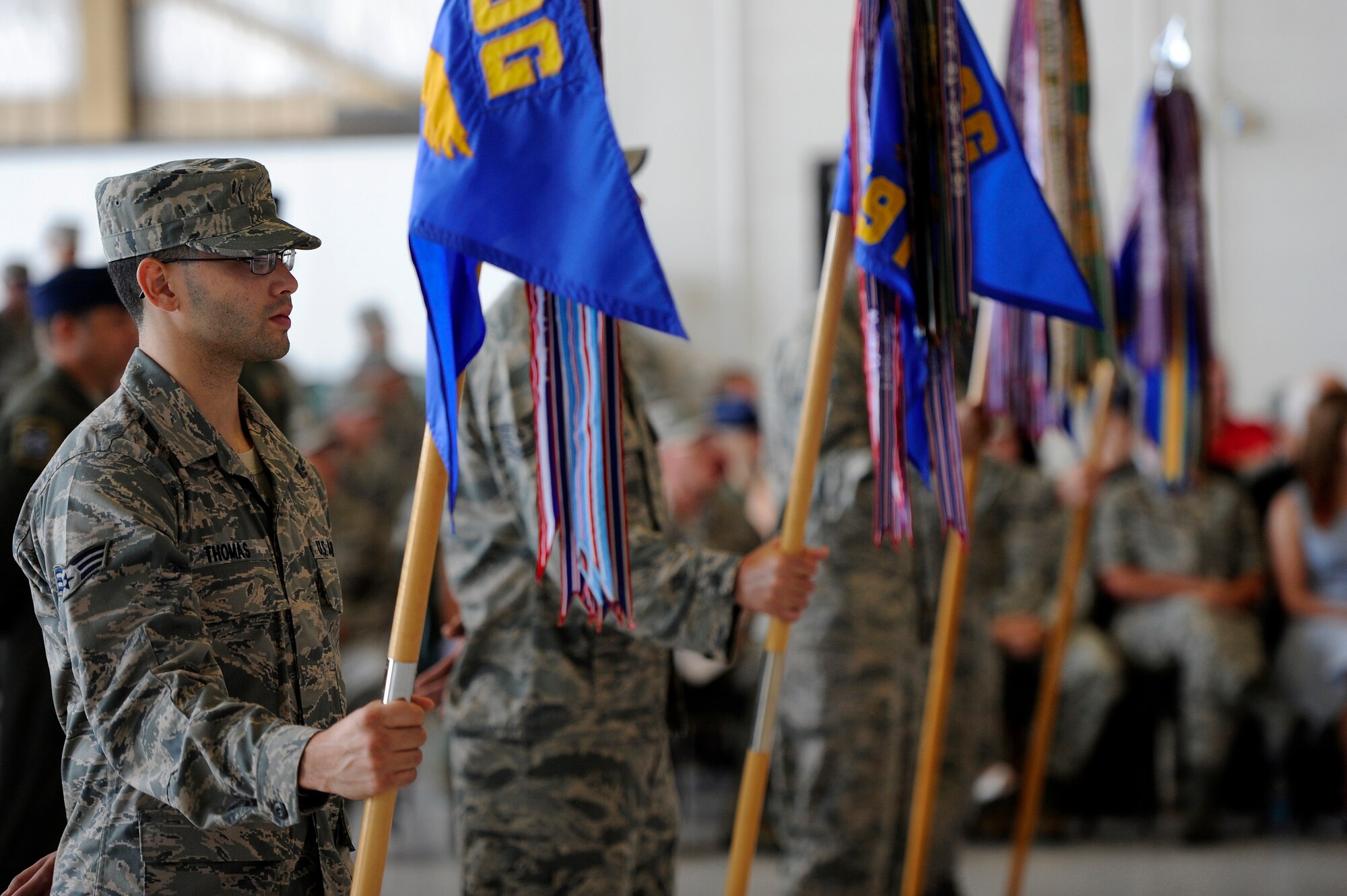 U.S. Air Force Senior Airman Dwight Thomas, 20th Operations Group, holds his unit’s flag while standing in formation during the 20th Operations Group change of command ceremony, June 22, 2012, Shaw Air Force Base, S.C. Each 20th Fighter Wing group was represented during the ceremony as Col.  James Sears, outgoing 20th OG commander, relinquished command to Col. Shaun McGrath, incoming 20th OG commander. Sears will be taking a new assignment at Columbus Air Force Base, Miss. (U.S. Air Force photo by Senior Airman Kenny Holston/Released)