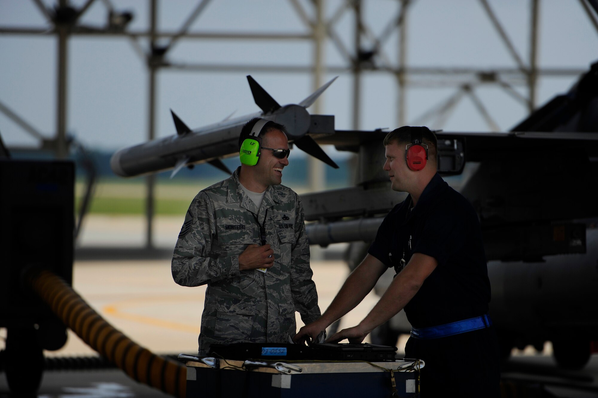 U.S. Air Force Master Sgt. George Monteiro, 20th Aircraft Maintenance Squadron, talks with one of his crew chiefs as the crew chief gets his equipment together before prepping an F-16 Fighting Falcon for launch, June 19, 2012, Shaw Air Force Base, S.C. With aircraft maintenance being performed around the clock and Airmen working long hours, senior NCO’s like Monteiro are sure to get out to the flight line with their Airmen to ensure any needs their folks may have are taken care of so they are able to keep aircraft flying. (U.S. Air Force photo by Senior Airman Kenny Holston/Released)