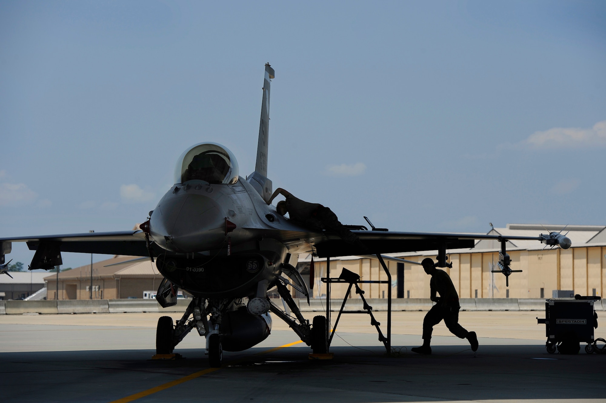 U.S. Air Force Staff Sgt. Tammy Thompson (left) and Airman 1st Class Tyrone Giraldo, both 20th Aircraft Maintenance Squadron crew chiefs, perform maintenance on an F-16 Fighting Falcon, June 19, 2012, Shaw Air force Base, S.C. Aircraft maintenance is an around the clock job for crew chiefs and maintainers stationed at Shaw. Airmen work hard to ensure aircraft are prepared for worldwide operations and short notice missions. (U.S. Air Force photo by Senior Airman Kenny Holston/Released)