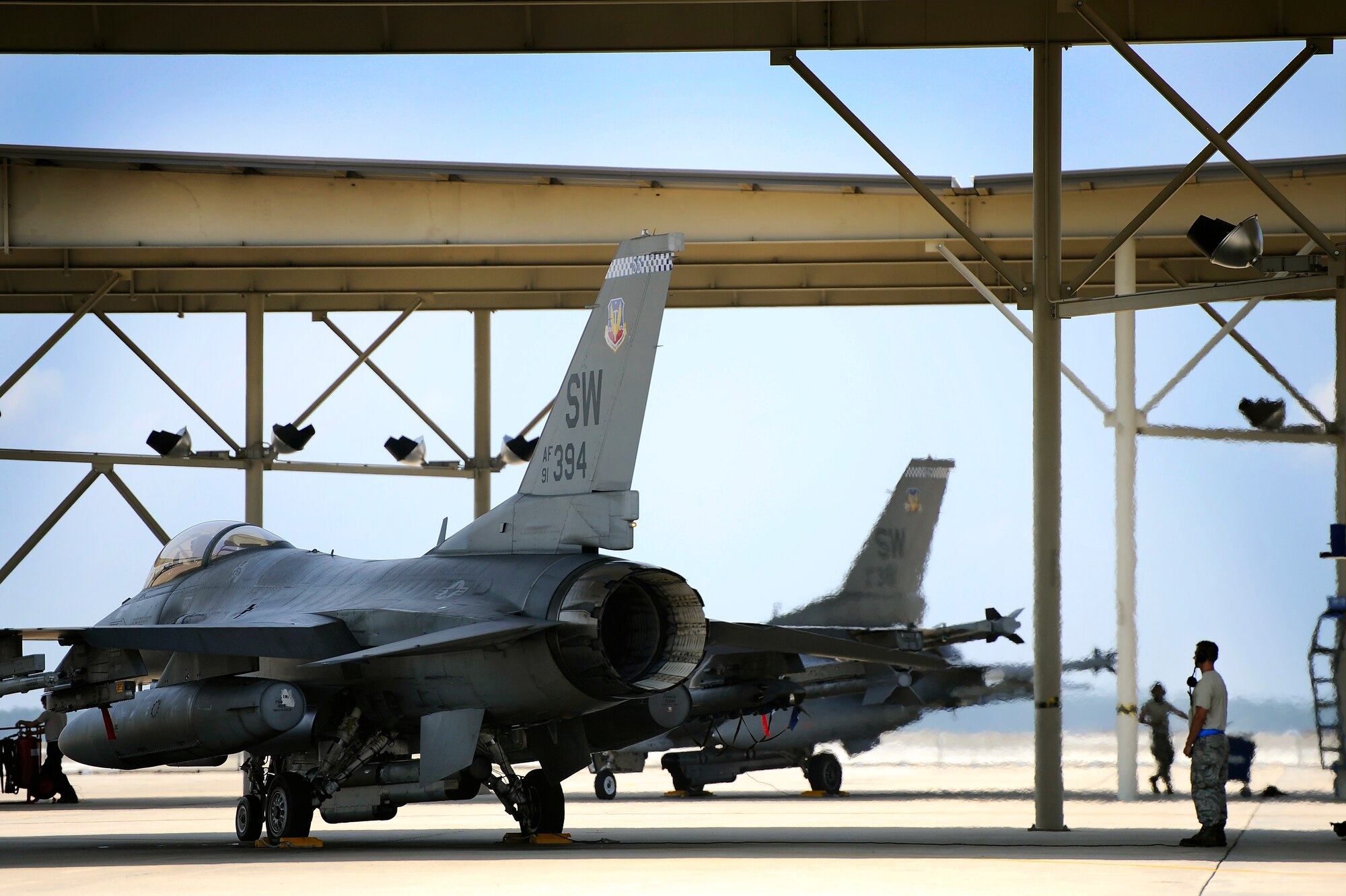 U.S. Air Force crew chiefs assigned to the 20th Aircraft Maintenance Squadron prepare F-16 Fighting Falcons for take off, June 19, 2012, Shaw Air Force Base, S.C. Crew chiefs assigned to the 20th AMXS work around the clock maintaining and launching F-16’s for three fighter squadrons assigned to the 20th Fighter Wing. (U.S. Air Force photo by Senior Airman Kenny Holston/Released)