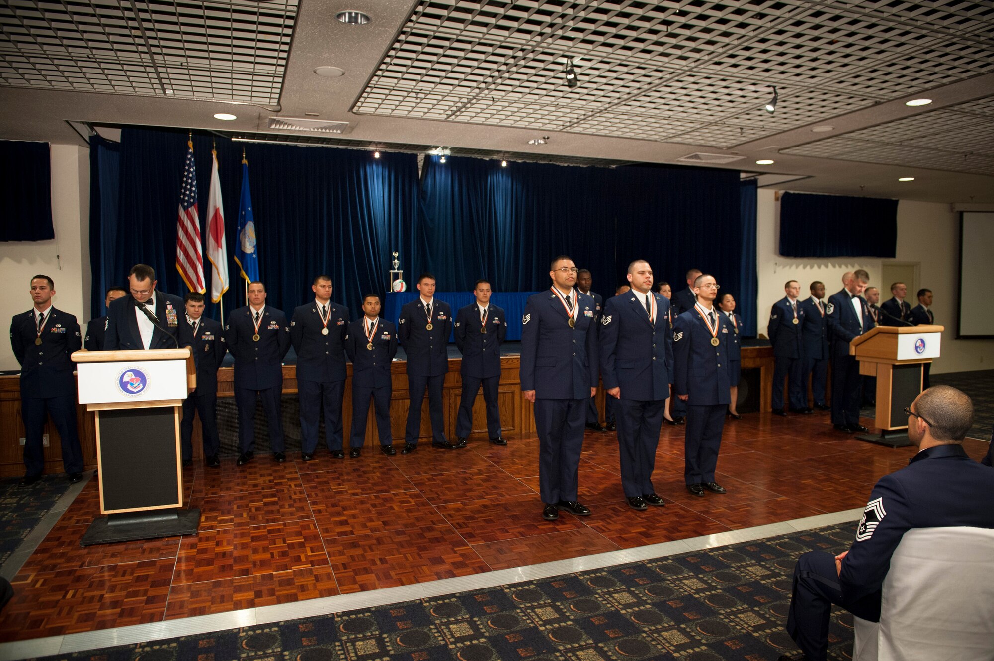 YOKOTA AIR BASE, Japan -- Staff sergeants graduating from Airman Leadership School Class 12-E accept the NCO charge at the end of their graduation ceremony at Yokota Air Base, Japan, June 21, 2012. (U.S. Air Force photo by Tech. Sgt. Samuel Morse)