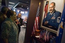 Hazel Lamb, daughter of fourth Chief Master Sgt. of the Air Force Thomas Barnes, studies a picture of her father at Stripes Enlisted Lounge at Laughlin Air Force Base, Texas, June 25, 2012. Hazel, along with her sisters Theresa Neal and Thyra Barnes, were guests of honor for a street renaming ceremony that honored their father, his time spent at Laughlin and service to the Air Force. (U.S. Air Force photo/Airman 1st Class Nathan Maysonet)