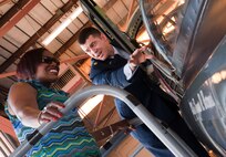 Theresa Neal, daughter of the fourth Chief Master Sgt. of the Air Force Thomas Barnes, is shown the cockpit of a T-38 aircraft by Maj. Douglas Kabel, 47th Flying Training Wing director of staff, on Laughlin Air Force Base, Texas, June 25, 2012. Theresa, along with her sisters Hazel Lamb and Thyra Barnes, were guests of honor for a street renaming ceremony that honored their father, his time spent at Laughlin and service to the Air Force. (U.S. Air Force photo/Airman 1st Class Nathan Maysonet)