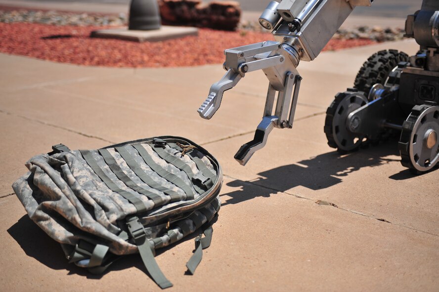 The Andros F6A robot, controlled by U.S. Air Force Explosive  Ordinance Disposal team members, collects a backpack containing an improvised explosive device during a hostile threat exercise at Cannon Air Force Base, N.M., June 20, 2012. Air Commandos responded quickly to maintain control of the situation. (U.S. Air Force photo by Airman 1st Class Eboni Reece)