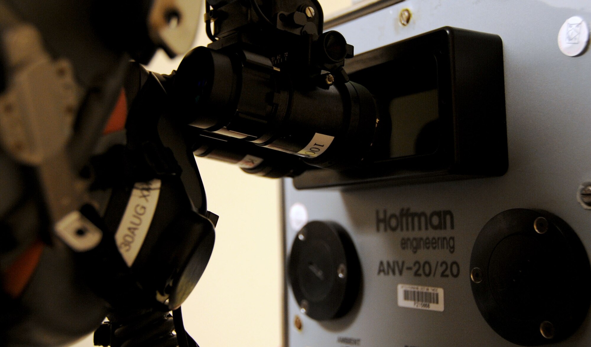 Airman 1st Class Tyler Shepherd, 2nd Operations Support Squadron aircrew flight equipment apprentice prepares to calibrate a pair of AN/AVS-9 night vision goggles by looking through a Hoffman 20/20 machine on Barksdale Air Force Base, La., June 21. The Hoffman is used to calibrate the NVGs to the pilot's eyesight. This process is done in the dark to protect the image intensifier inside the goggles. (U.S. Air Force photo/Senior Airman La'Shanette V. Garrett)(RELEASED)