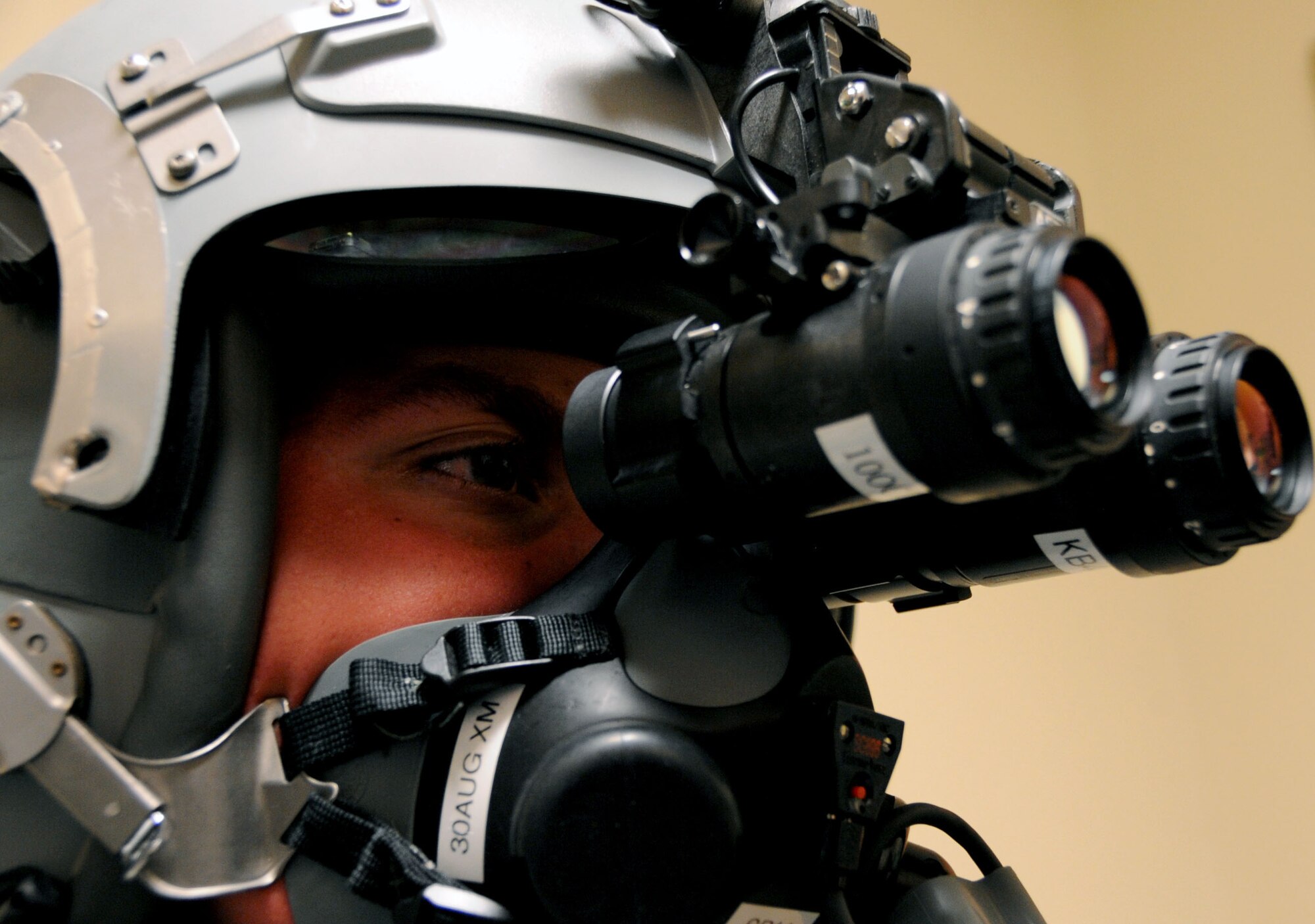 Airman 1st Class Tyler Shepherd, 2nd Operations Support Squadron aircrew flight equipment apprentice, dons HGU-55/P flight equipment with a pair of night vision goggles attached on Barksdale Air Force Base, La., June 21. NVGs help aircrew fly at night and in low-light situations, stay in formation with other aircraft, find and bomb targets and avoid dangerous weather. (U.S. Air Force photo/Senior Airman La'Shanette V. Garrett)(RELEASED)