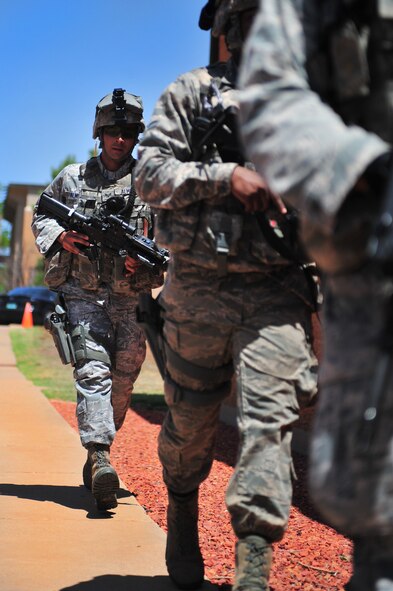 U.S. Air Force Senior Airman Jared Almengor, 27th Special Operations Security Forces Deployed Aircraft Ground Response Element team, follows behind other 27 SOSFS DAGRE team members during a hostile threat exercise at Cannon Air Force Base, N.M., June 20, 2012. Air Commandos responded quickly to maintain control of the situation. (U.S. Air Force photo by Airman 1st Class Eboni Reece)