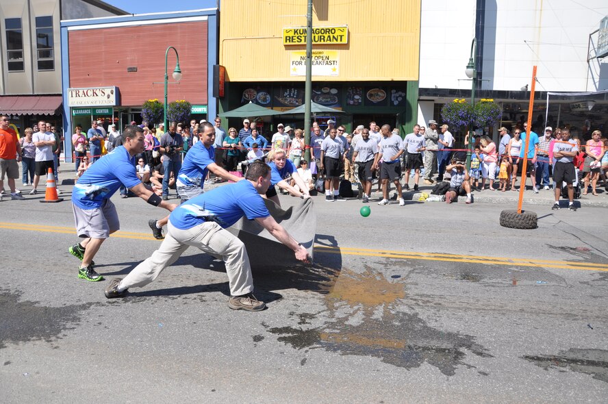 Members of the 477th Fighter Group participate in the Hero Games Water Balloon Volleyball. The Hero Games are a day-long friendly competition between the police, troopers, each military branch and the fire department that takes place in downtown Anchorage during the Summer Solstice Festival. The teams were challenged with events such as the obstacle course, a "rescue the cat" climb, litter carry, the bucket brigade and tricycle races. On the longest day of the year – summer solstice – Anchorage, Alaska, gets 22 hours of functional daylight. (U.S. Air Force Photo/Capt. Ashley Conner)