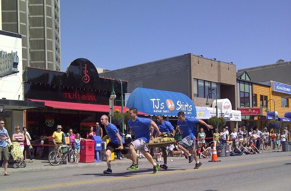 Members of the 477th Fighter Group participate in the Hero Games Litter Carry event. The Hero Games are a day-long friendly competition between the police, troopers, each military branch and the fire department that takes place in downtown Anchorage during the Summer Solstice Festival. The teams were challenged with events such as the obstacle course, a "rescue the cat" climb, litter carry, the bucket brigade and tricycle races. On the longest day of the year – summer solstice – Anchorage, Alaska, gets 22 hours of functional daylight. (U.S. Air Force Photo/Master Sgt. Rhodora Maher)