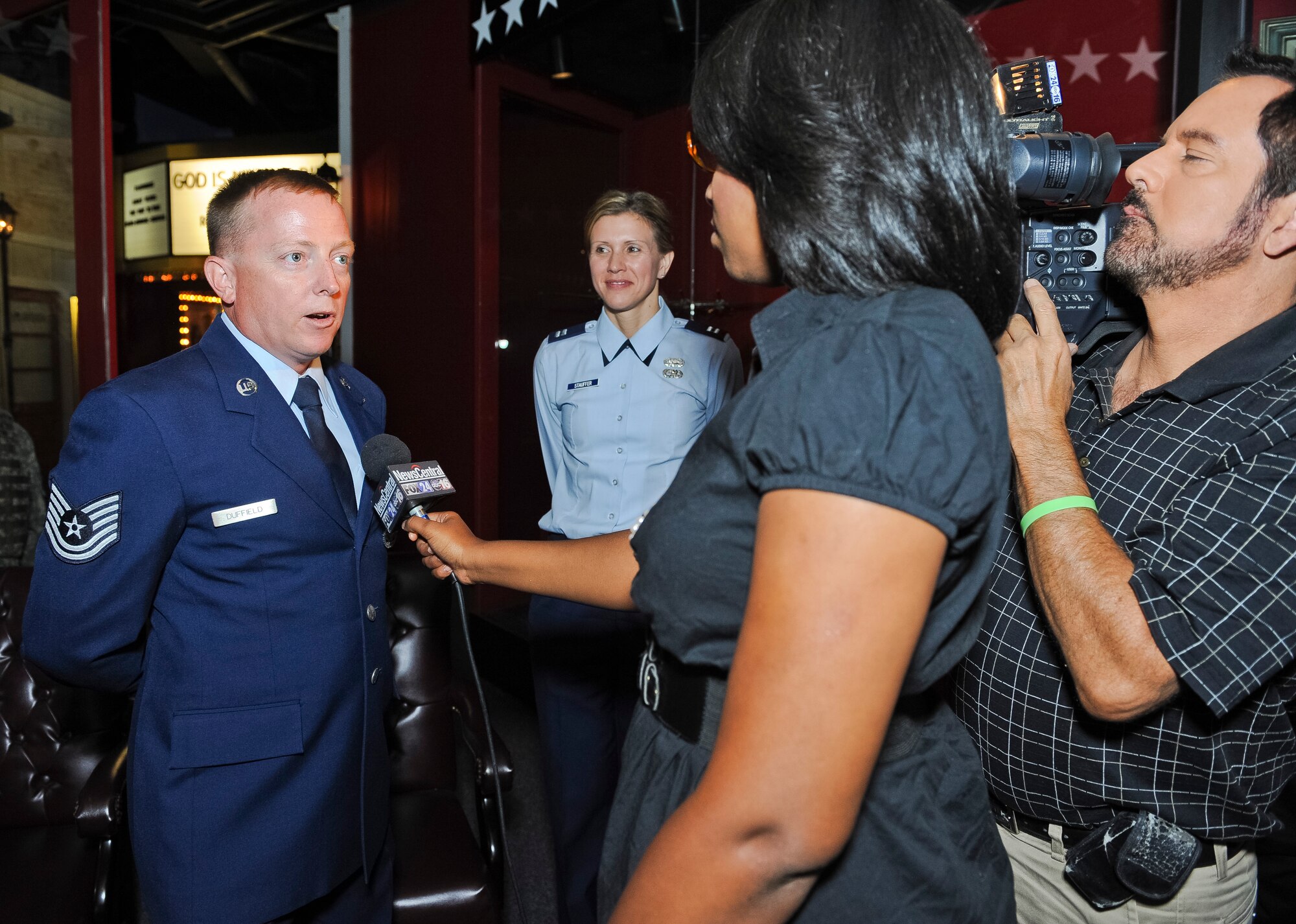 Tech. Sgt. Barry Duffield, 116th Civil Engineering Squadron explosive ordnance technician, is interviewed by Fox 24 News after a ceremony where Duffield was awarded the Bronze Star Medal at the Museum of Aviation, Robins Air Force Base, Ga., June 18, 2012.  Duffield received the medal, his 2nd, for his achievements while serving as an explosive ordnance disposal team leader in Afghanistan during a six-month period from 2011 to 2012.  Capt. Pamela Stauffer, 116th Air Control Wing public affairs officer, looks on during the interview.  (National Guard photo by Master Sgt. Roger Parsons/Released)