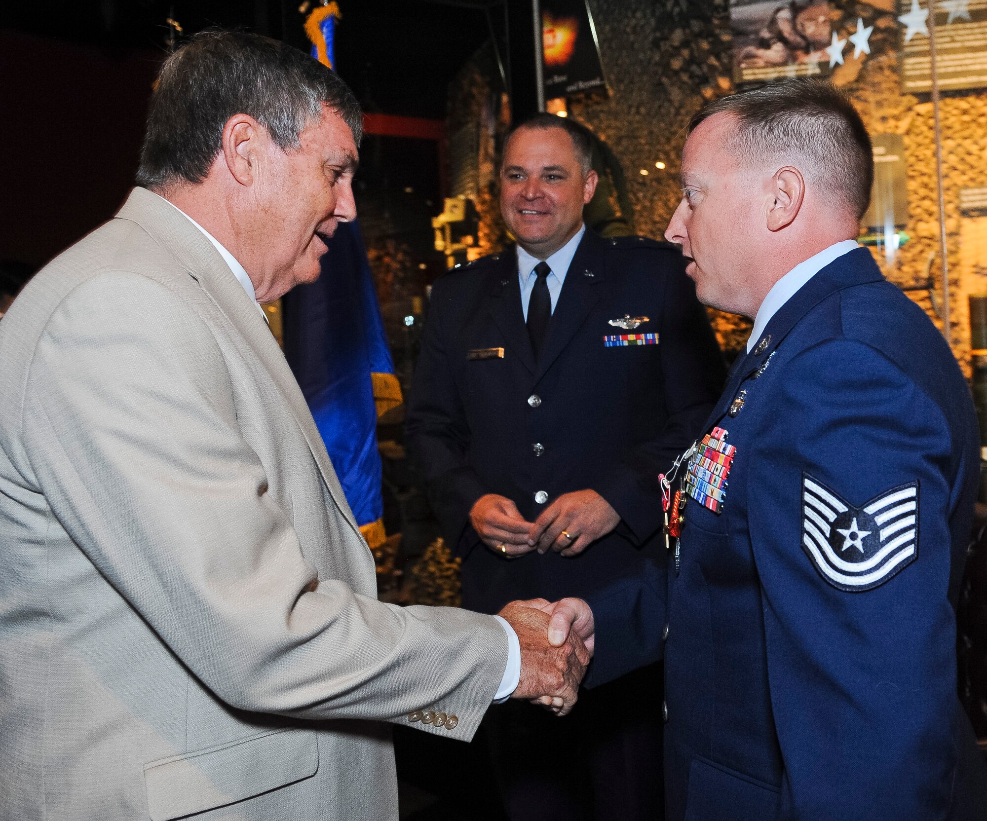 John Harley, Centerville, Ga., mayor, congratulates Tech. Sgt. Barry Duffield, 116th Civil Engineering Squadron explosive ordnance technician, during a ceremony where Duffield received the Bronze Star Medal while Maj. Gen. Jim Butterworth, Georgia National Guard adjutant general, looks on at the Museum of Aviation, Robins Air Force Base, Ga., June 18, 2012.  Butterworth presented Duffield the medal, his 2nd, for his achievements while serving as an explosive ordnance disposal team leader in Afghanistan during a six-month period from 2011 to 2012.  (National Guard photo by Master Sgt. Roger Parsons/Released)