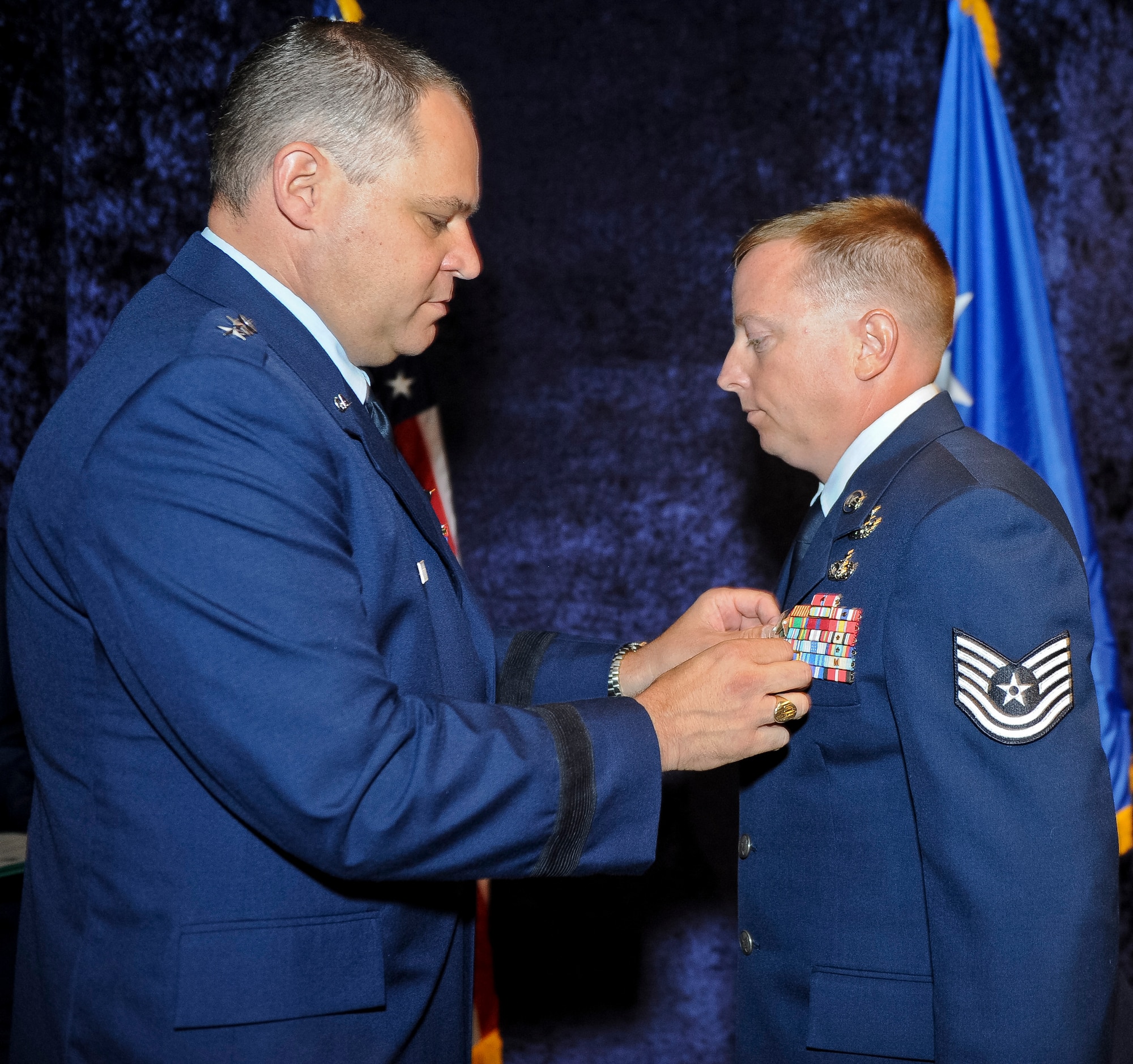 Maj. Gen. Jim Butterworth, Georgia National Guard adjutant general, pins a Bronze Star Medal on Tech. Sgt. Barry Duffield, 116th Civil Engineering Squadron explosive ordnance technician, during a ceremony at the Museum of Aviation, Robins Air Force Base, Ga., June 18, 2012.  Duffield received the medal, his 2nd, for his achievements while serving as an explosive ordnance disposal team leader in Afghanistan during a six-month period from 2011 to 2012.  ( National Guard photo by Master Sgt. Roger Parsons/Released)