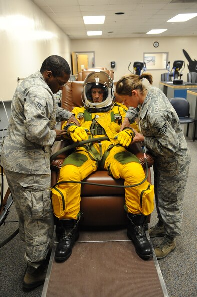 (Left) Senior Airman Michael Gaines and (right) Staff Sgt. Tara Schmidt, , 9th Physiological Support Squadron life support technicians, dress Chief Masters Sgt. Richard Parsons, command chief of Air Combat Command, in a U-2 Dragon Lady pressure suit at the 9th PSPTS integration room June 21, 2012 at Beale Air Force Base, Calif.  Parsons was visiting base facilities and meeting Airmen from units and organizations responsible for accomplishing the mission of the 9th Reconnaissance Wing and tenant units. (U.S. Air Force photo by Mr. John Schwab)