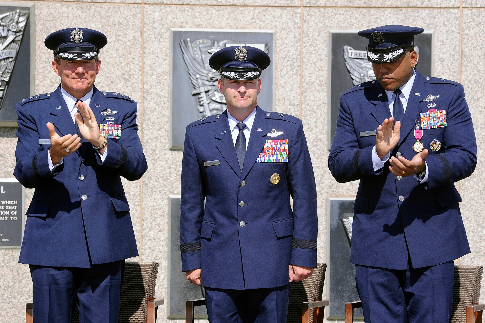 Academy Superintendent Lt. Gen. Mike Gould, left, and outgoing Commandant of Cadets Brig. Gen Richard Clark applaud Brig. Gen. Gregory Lengyel during the change of command ceremony June 25. Lengyel comes to the Academy from Supreme Headquarters Allied Powers Europe, NATO, in Mons, Belgium, where he was the executive officer to the Supreme Allied Commander in Europe.. (U.S. Air Force Photo/Mike Kaplan)