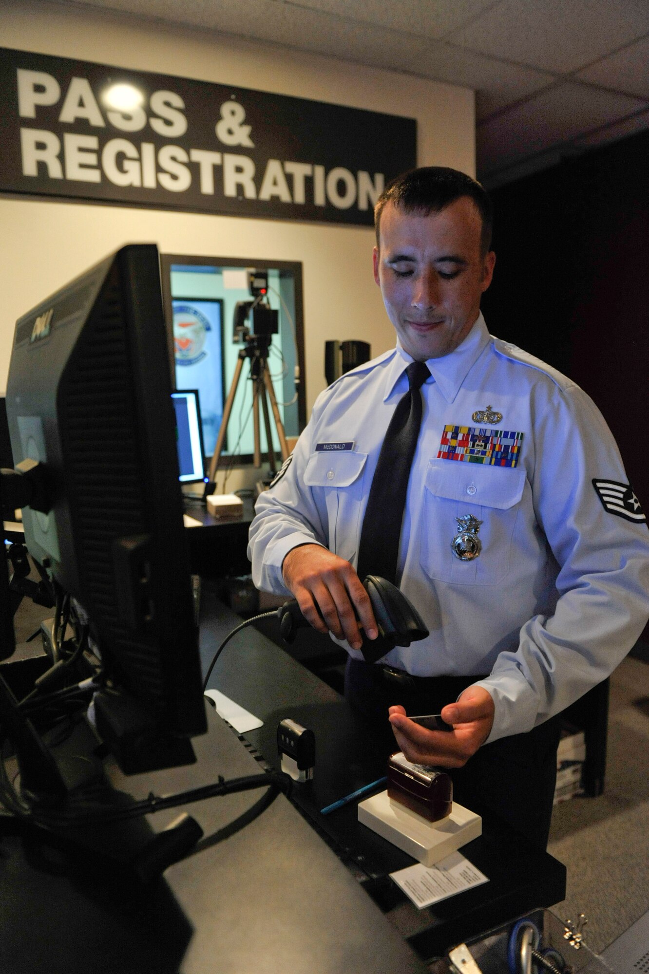 Staff Sgt. Justin McDonald, a 19th Security Forces Squadron non-commissioned officer in charge of pass and registration, scans an identification card for Defense Biometric Identification System registration June 25, 2012, at Little Rock Air Force Base, Ark. McDonald discovered and corrected a security weakness in the contractor badge issuing process.
(U.S. Air Force photo/A1C Rusty Frank)
