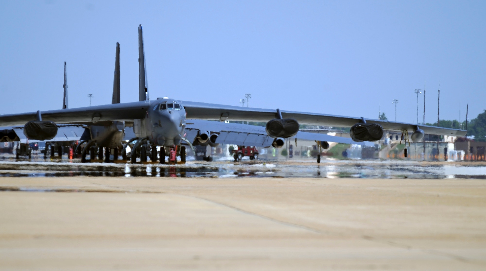 B-52H Stratofortress bombers sit on the flightline on Barksdale Air Force Base, La., June 25. Due to constant exposure to sunlight, a B-52 must be painted every four years to maintain its dark grey color. The dark grey color helps the B-52 blend in when flying at higher altitudes, at night or over large bodies of water. (U.S. Air Force photo/Airman 1st Class Micaiah Anthony)(RELEASED)  
