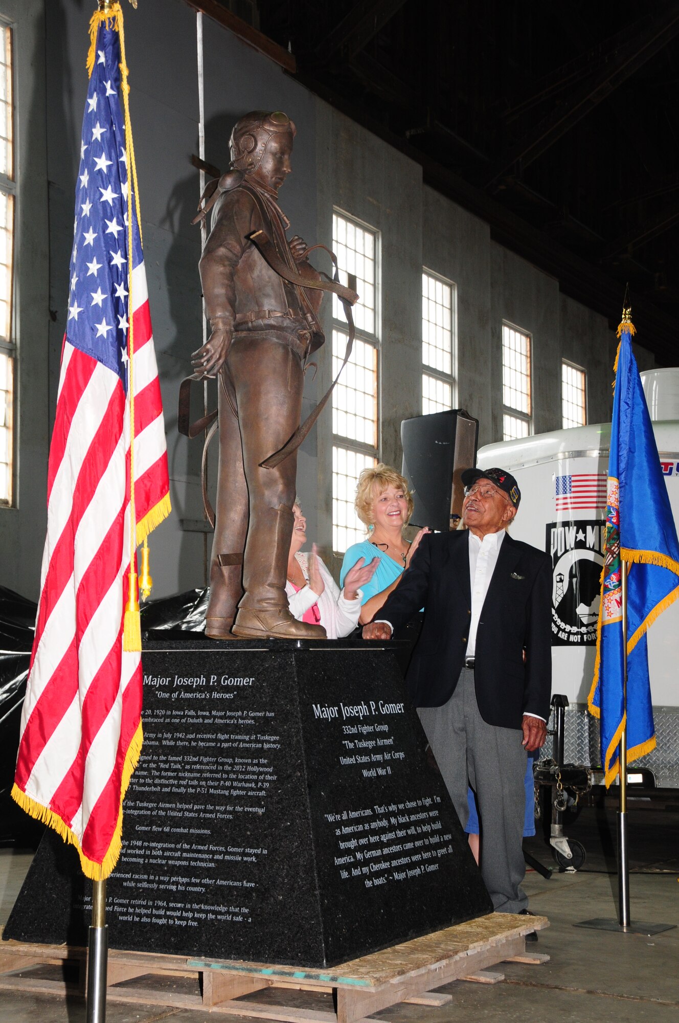 Maj. (Ret.) Joe Gomer, a Tuskegee Airman and Duluth native, looks at the
statue dedicated to his service in World War II during a ceremony at the
Commemorative Air Force hangar, Duluth, Minn. June 23, 2012. (National Guard
photo by Staff Sgt. Don L. Acton.)
