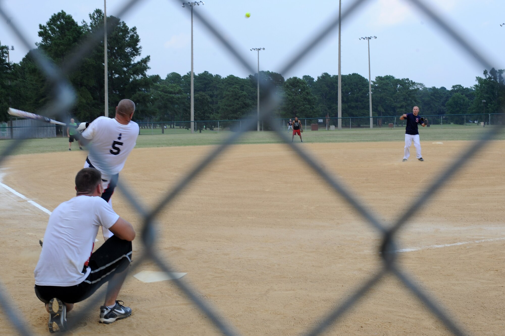 U.S. Air Force Master Sgt. Tony Patrick hits a ball to left field during the base intramural softball championship game on Seymour Johnson Air Force Base, N.C., June 21, 2012. After eight innings of play, Ammo won 13 to 4. Patrick, 4th Equipment Maintenance Squadron munitions inspector, is from Billings, Mont. (U.S. Air Force photo/Airman 1st Class John Nieves Camacho/Released)