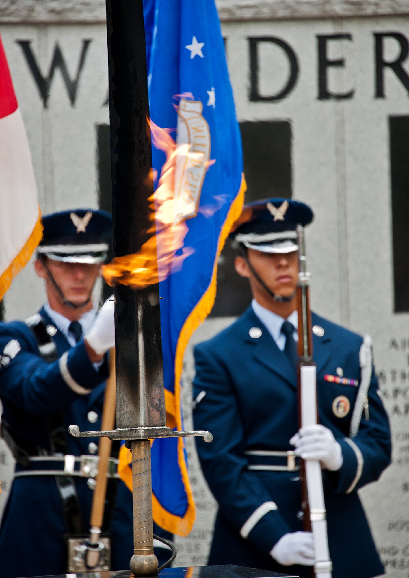 The flaming sword of remembrance burns amid high winds caused by Tropical Storm Debby, while Eglin Honor Guard members present the colors during the Khobar Towers Memorial ceremony June 25 at Eglin Air Force Base, Fla.  The ceremony marked the 16th anniversary of the tragedy of the Khobar Towers bombing that killed 19 military members and 12 33rd Fighter Wing Nomads.  (U.S. Air Force photo/Samuel King Jr.)