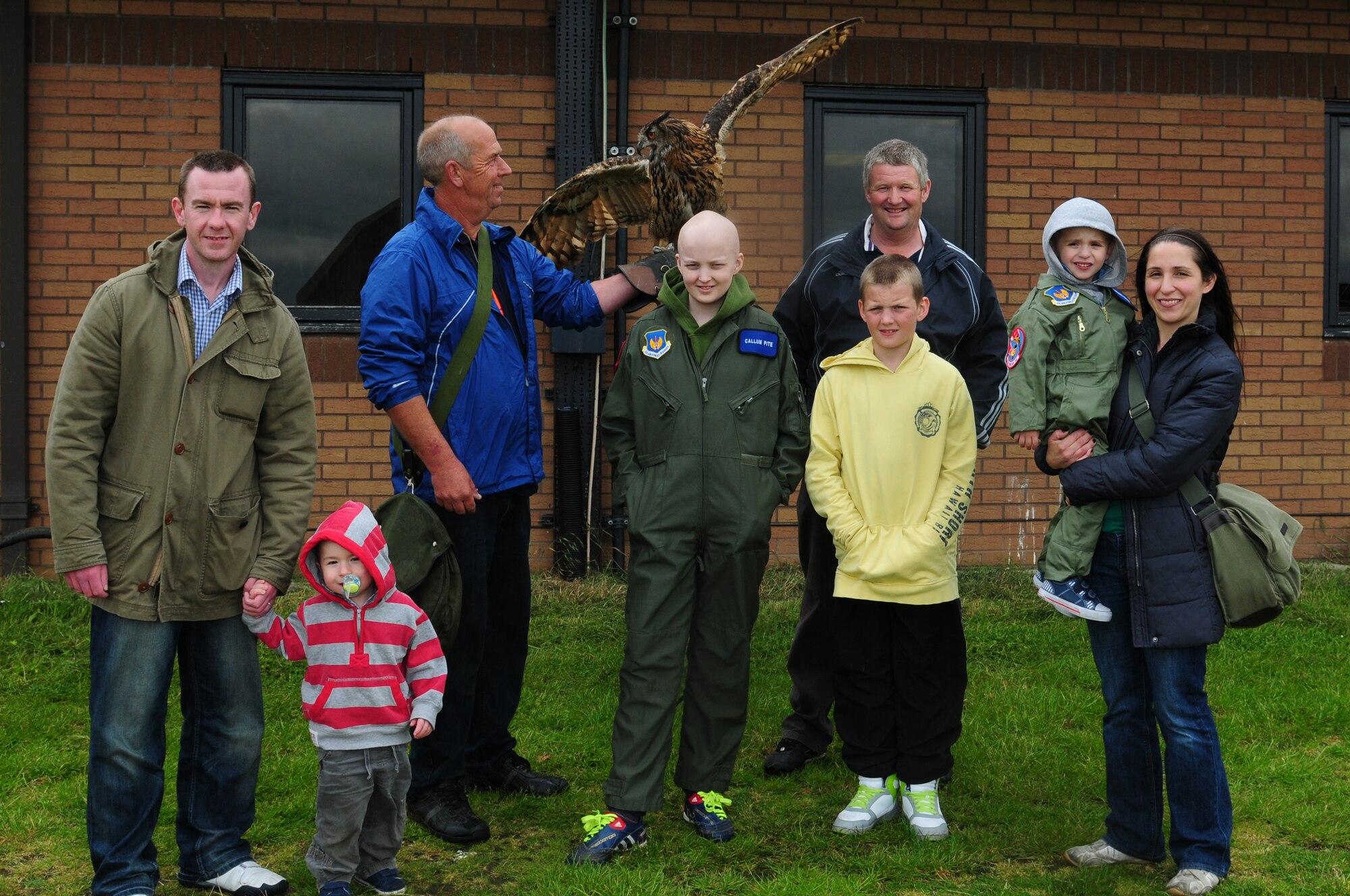ROYAL AIR FORCE LAKENHEATH, England – The Carr and Pite families pose with Twinkle, 24-year-old eagle owl, and Keith Mutton, Phoenix Bird Control handler, during a Pilot for A Day tour June 22, 2012.  The Pilot for a Day program is new to RAF Lakenheath and provides children in the local community who are fighting life-threatening illnesses or conditions a day of learning and fun as a break from doctor visits. (U.S. Air Force photo by Airman 1st Class Cory D. Payne)
