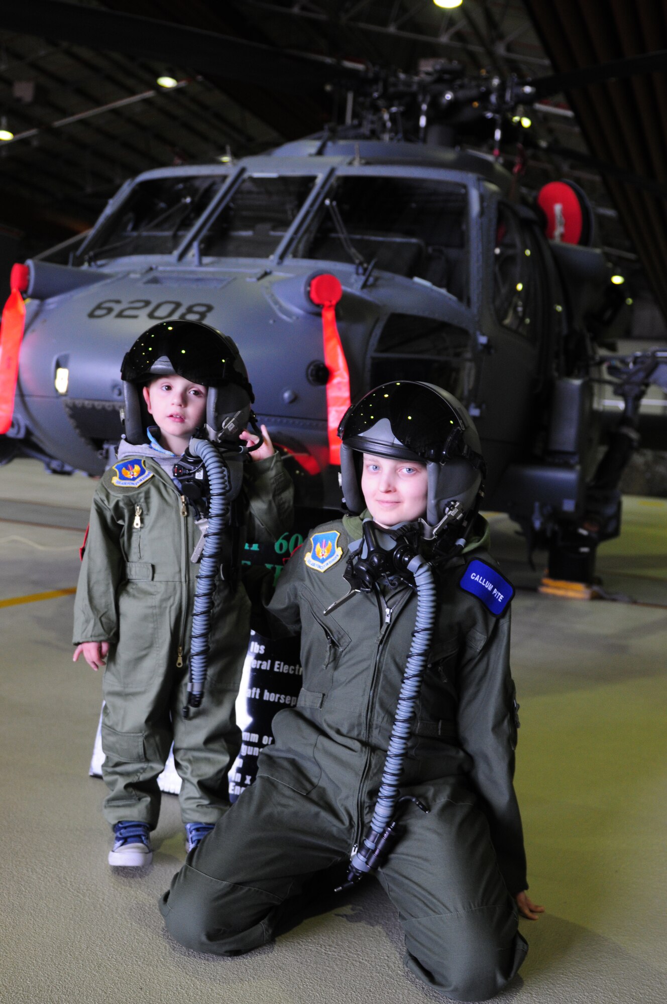 ROYAL AIR FORCE LAKENHEATH, England – Callum Carr (left), 4-year-old, and Callum Pite, 14-year-old, pose in front of an HH-60G Pave Hawk during a Pilot for A Day tour June 22, 2012.  The Pilot for a Day program is new to RAF Lakenheath and provides children in the local community who are fighting life-threatening illnesses or conditions a day of learning and fun as a break from doctor visits. (U.S. Air Force photo by Airman 1st Class Cory D. Payne)