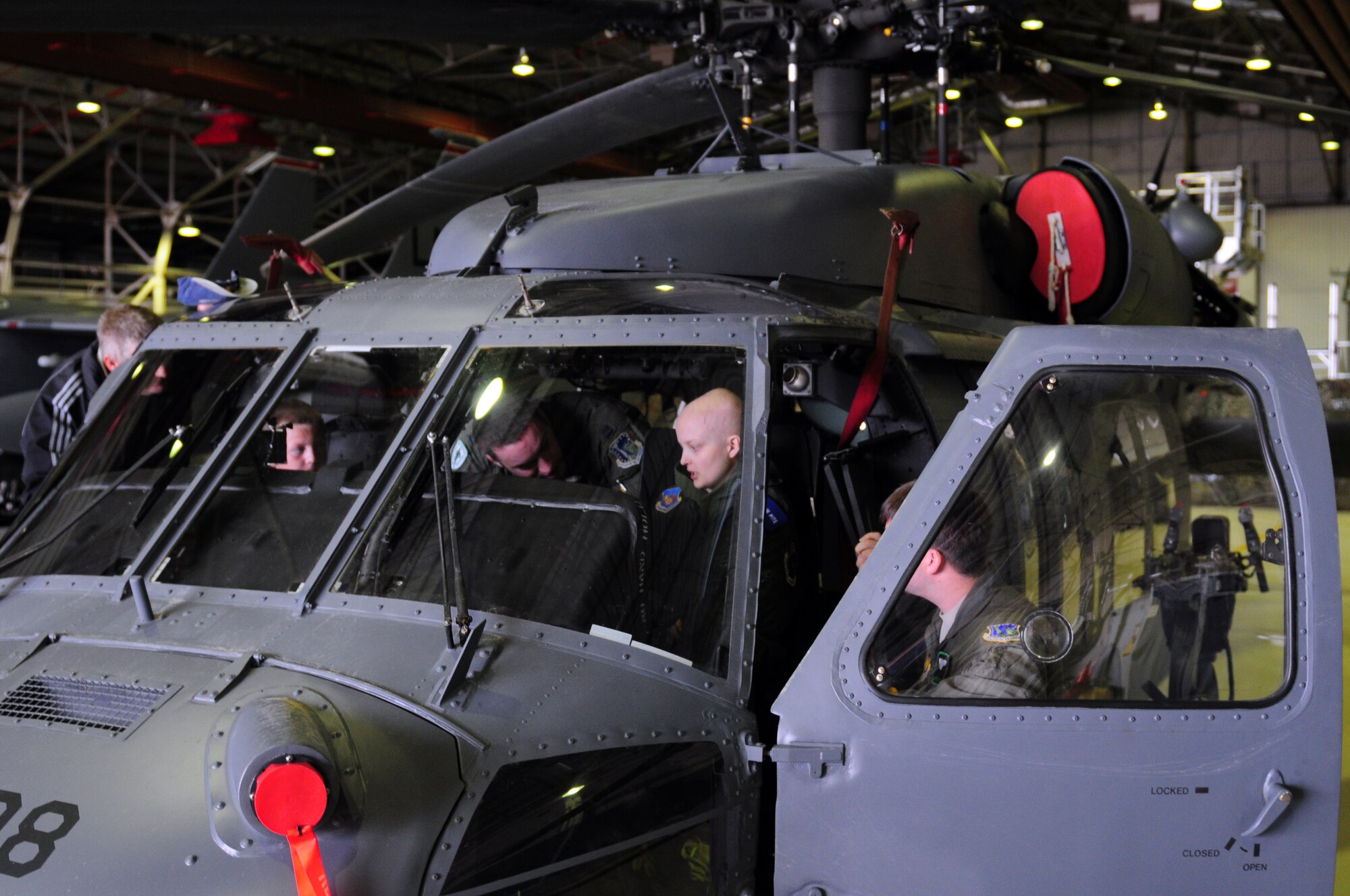 ROYAL AIR FORCE LAKENHEATH, England – The Pite family take a hands on tour of an HH-60G Pave Hawk during a Pilot for A Day tour June 22, 2012.  Callum Pite was diagnosed with from bone cancer and is undergoing treatment in Cambridge. The Pilot for a Day program is new to RAF Lakenheath and provides children in the local community who are fighting life-threatening illnesses or conditions a day of learning and fun as a break from doctor visits. (U.S. Air Force photo by Airman 1st Class Cory D. Payne)