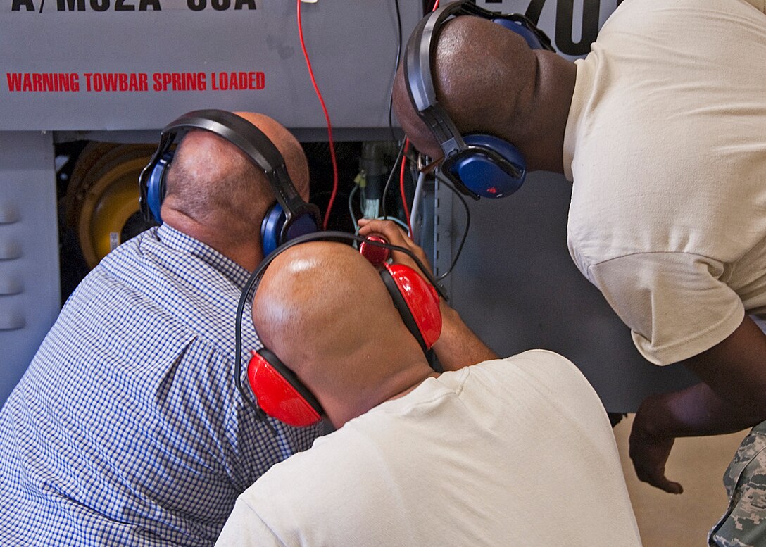Henry Castro, Senior Airman Mychal Hamilton and Staff Sgt. Christopher Goff of the 361st Training Squadron, check the gas turbine generator wiring to trouble shoot an electrical problem in a practice scenario set up by their instructor on June 8, 2011 at Sheppard Air Force Base, Texas. (U.S. Air Force photo/Frank H.Carter)