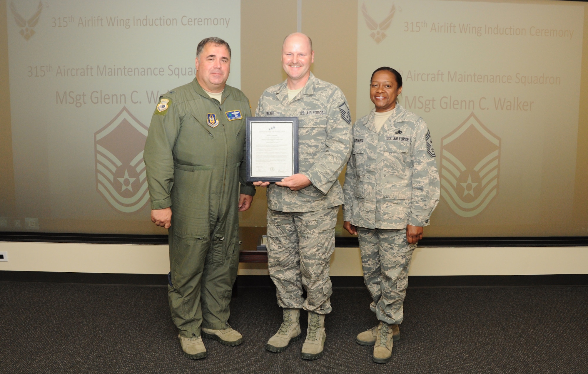 Master Sgt. Glenn Walker is honored as a new Senior NCO during a 315th Airlift Wing SNCO induction ceremony June 23, 2012 at Joint Base Charleston, S.C. Col. Terry Lawrence, 315 AW Operations Group commander, and Chief Master Sgt. Gigi Manning, 315 AW command chief master sergeant, presided over the event. Sergeant Walker works with the 315 AW Aircraft Maintenance Squadron. (U.S. Air Force Photo/Staff Sgt. Shane Ellis)