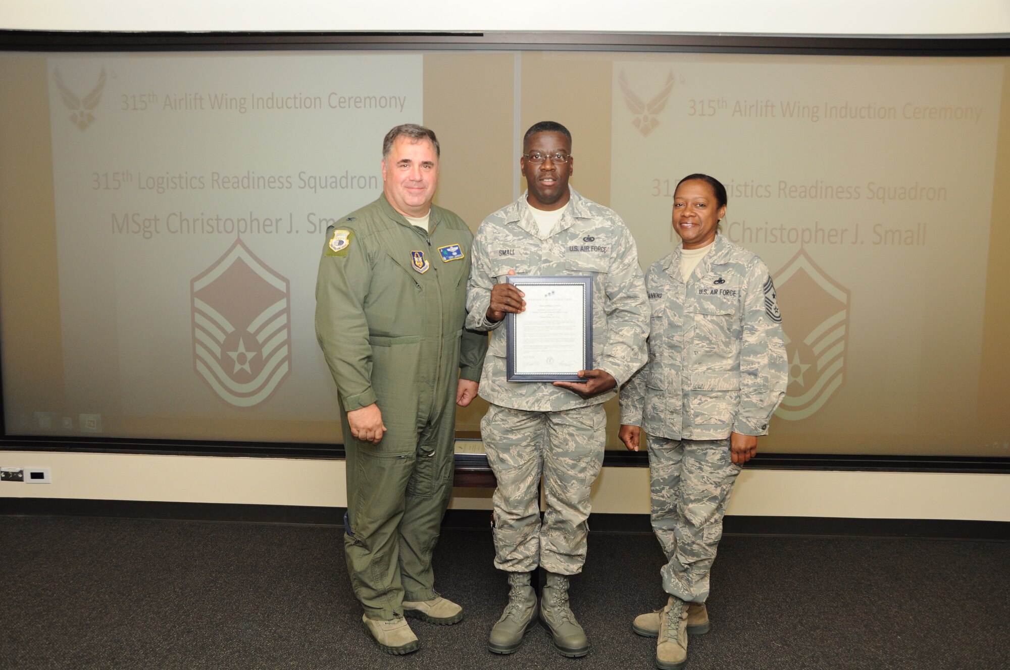 Master Sgt. Christopher Small is honored as a new Senior NCO during a 315th Airlift Wing SNCO induction ceremony June 23, 2012 at Joint Base Charleston, S.C. Col. Terry Lawrence, 315 AW Operations Group commander, and Chief Master Sgt. Gigi Manning, 315 AW command chief master sergeant, presided over the event. Sergeant Small works with the 315 AW Logistics Readiness Squadron. (U.S. Air Force Photo/Staff Sgt. Shane Ellis)