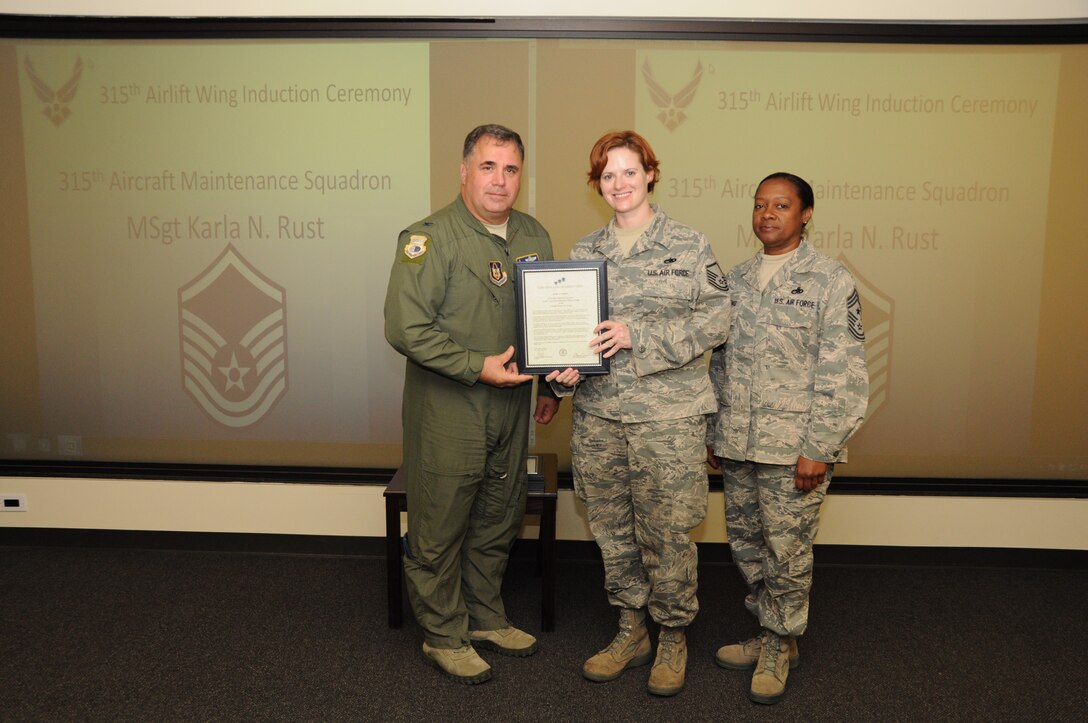 Master Sgt. Karla Rust is honored as a new Senior NCO during a 315th Airlift Wing SNCO induction ceremony June 23, 2012 at Joint Base Charleston, S.C. Col. Terry Lawrence, 315 AW Operations Group commander, and Chief Master Sgt. Gigi Manning, 315 AW command chief master sergeant, presided over the event. Sergeant Rust works with the 315 AW Aircraft Maintenance Squadron. (U.S. Air Force Photo/Staff Sgt. Shane Ellis)