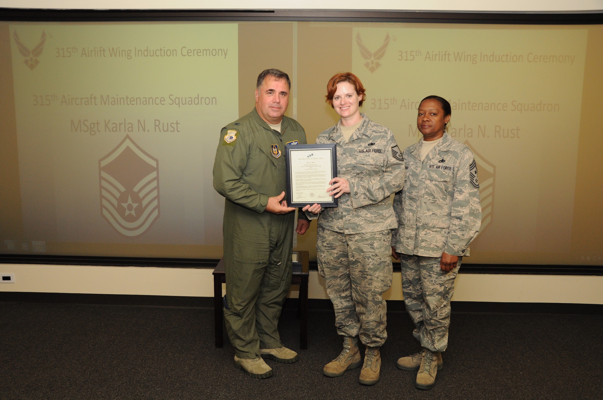 Master Sgt. Karla Rust is honored as a new Senior NCO during a 315th Airlift Wing SNCO induction ceremony June 23, 2012 at Joint Base Charleston, S.C. Col. Terry Lawrence, 315 AW Operations Group commander, and Chief Master Sgt. Gigi Manning, 315 AW command chief master sergeant, presided over the event. Sergeant Rust works with the 315 AW Aircraft Maintenance Squadron. (U.S. Air Force Photo/Staff Sgt. Shane Ellis)