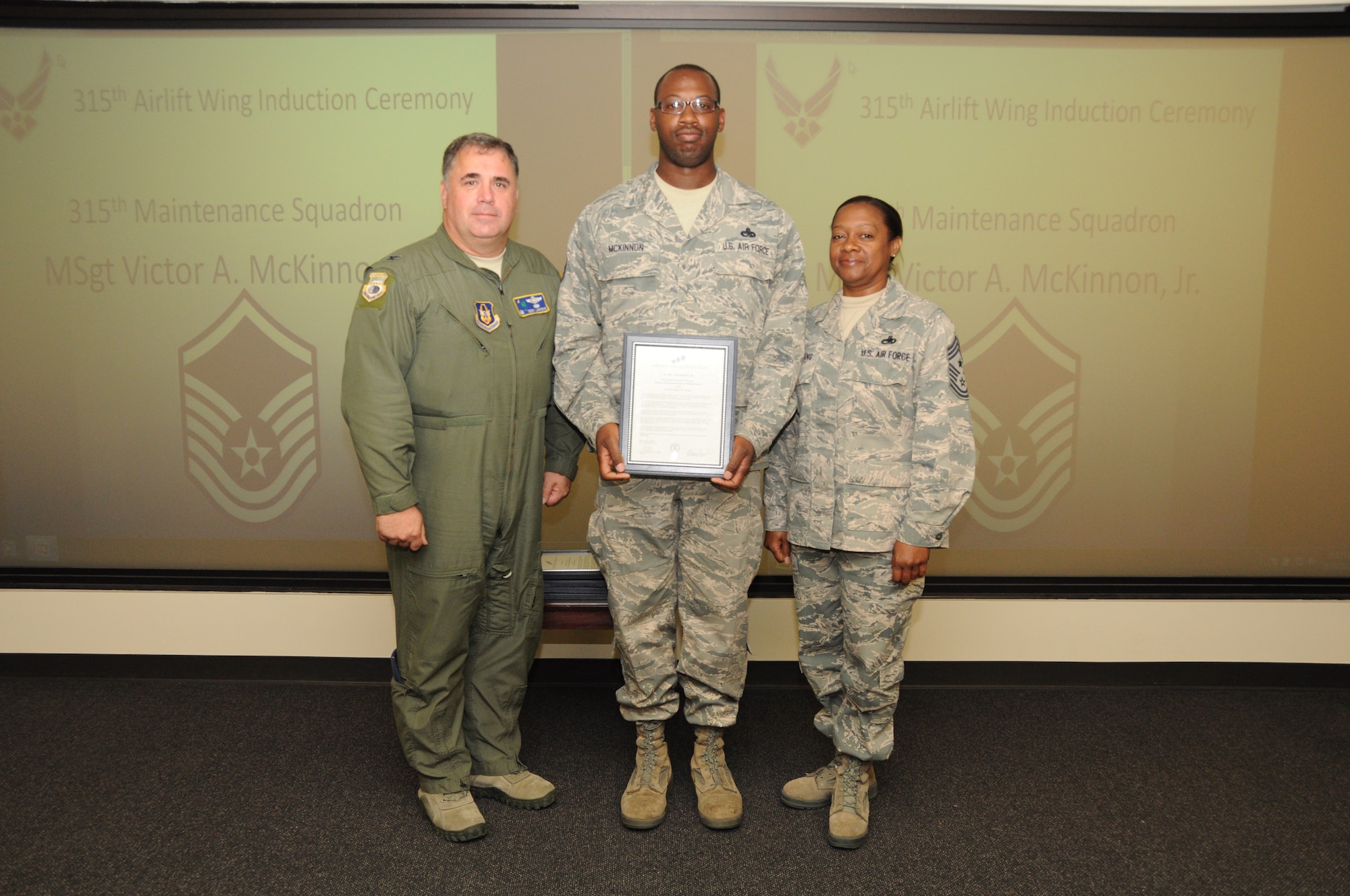 Master Sgt. Victor McKinnon is honored as a new Senior NCO during a 315th Airlift Wing SNCO induction ceremony June 23, 2012 at Joint Base Charleston, S.C. Col. Terry Lawrence, 315 AW Operations Group commander, and Chief Master Sgt. Gigi Manning, 315 AW command chief master sergeant, presided over the event. Sergeant McKinnon works with the 315 AW Maintenance Squadron. (U.S. Air Force Photo/Staff Sgt. Shane Ellis)
