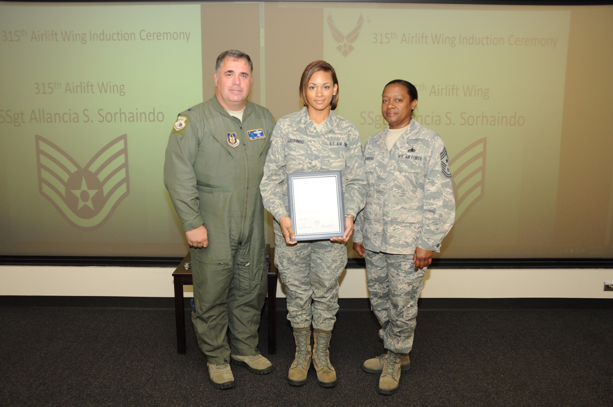 Staff Sgt. Allancia Sorhaindo is honored as a new NCO during a 315th Airlift Wing NCO induction ceremony June 23, 2012 at Joint Base Charleston, S.C. Col. Terry Lawrence, 315 AW Operations Group commander, and Chief Master Sgt. Gigi Manning, 315 AW command chief master sergeant, presided over the event. Sergeant Sorhaindo works with the 315 AW Financial Management. (U.S. Air Force Photo/Staff Sgt. Shane Ellis)