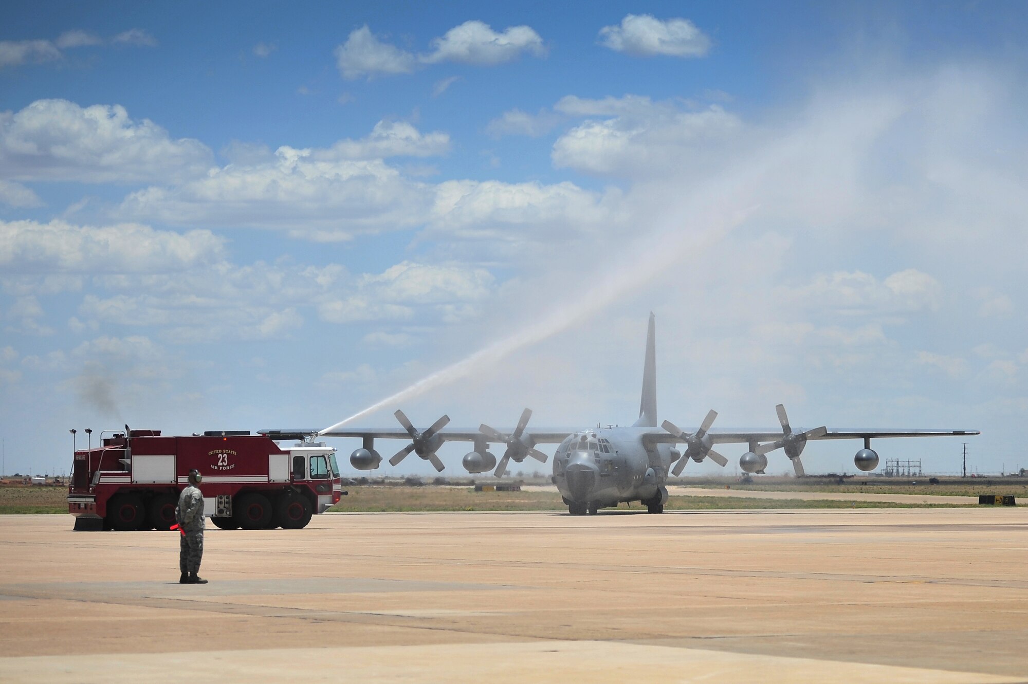 Trucks from the Cannon Air Force Base, N.M., fire department aim their hoses over an MC-130E Combat Talon I, tail number 64-0523, on the Cannon flightline during an aircraft retirement ceremony, June 22, 2012.  This particular Talon 1 was the lead aircraft that performed a Prisoner of War extraction in North Vietnam called the Son Tay Raid in 1970. (U.S. Air Force photo by Airman 1st Class Alexxis Pons Abascal)  