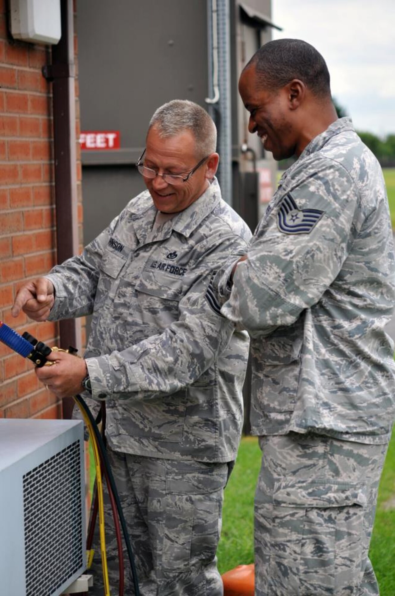 Master Sgt. Mike Johnson, 442nd Civil Engineers Squadron, trains Tech. Sgt. Tryemaine Curtis, 100th CES, how to annually check an HVAC system while on temporary duty at RAF Mildenhall, England. The 442nd CES is part of the 442nd Fighter Wing, an A-10 Thunderbolt II Air Force Reserve unit at Whiteman Air Force Base, Mo. (U.S. Air Force photo/Staff Sgt. Danielle Johnston)