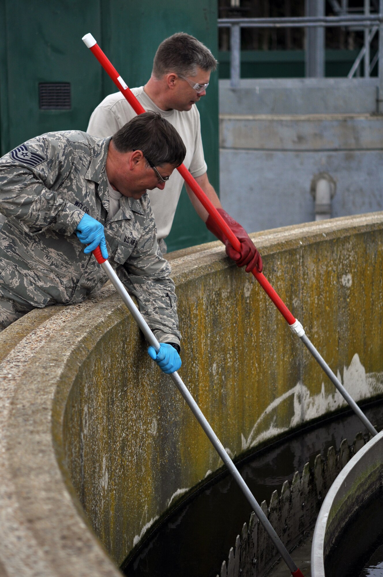 Tech. Sgt. Steve Welch and Staff Sgt. Tracy Tate, 442nd Civil Engineers Squadron, perform maintenance at the RAF Mildenhall water treatment facility while performing temporary duty in England, June 25, 2012. The 442nd CES is part of the 442nd Fighter Wing, an A-10 Thunderbolt Air Force Reserve unit at Whiteman Air Force Base, Mo.  (U.S. Air Force photo/Staff Sgt. Danielle Johnston)
