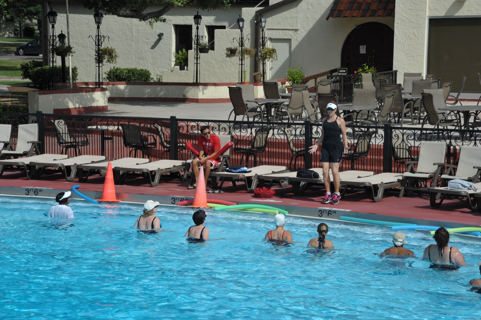 Water aerobics students at the Joint Base San Antonio-Randolph Center Pool follow along with the exercises taught by Lisa Glanzer, substitute instructor, June 20. (U.S. Air Force photo by Airman 1st Class Lincoln Korver)