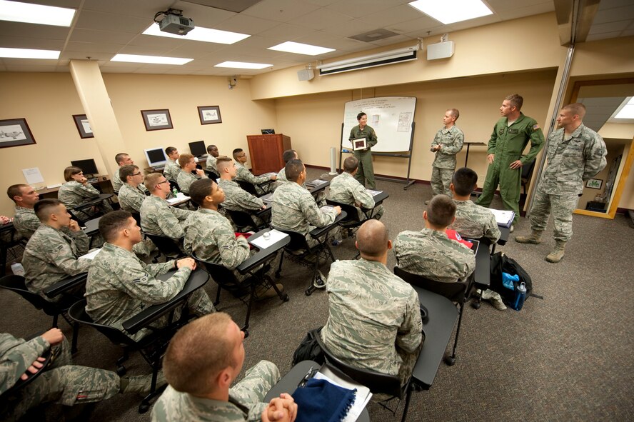 First-term Airmen watch as Staff Sgt. Holly John, 4th Special Operations Squadron, standing left, speaks about the significance of a squadron pin her squadron will give to the Commando Pride Airmen Center while at the center at Hurlburt Field, Fla., June 22, 2012. The pin belonged to Airman 1st Class John Levitow, an AC-47 gunship loadmaster of 3rd Special Operations Squadron, who earned the Medal of Honor for exceptional heroism during wartime. (U.S. Air Force photo by Airman 1st Class Benjamin Kim) (RELEASED)