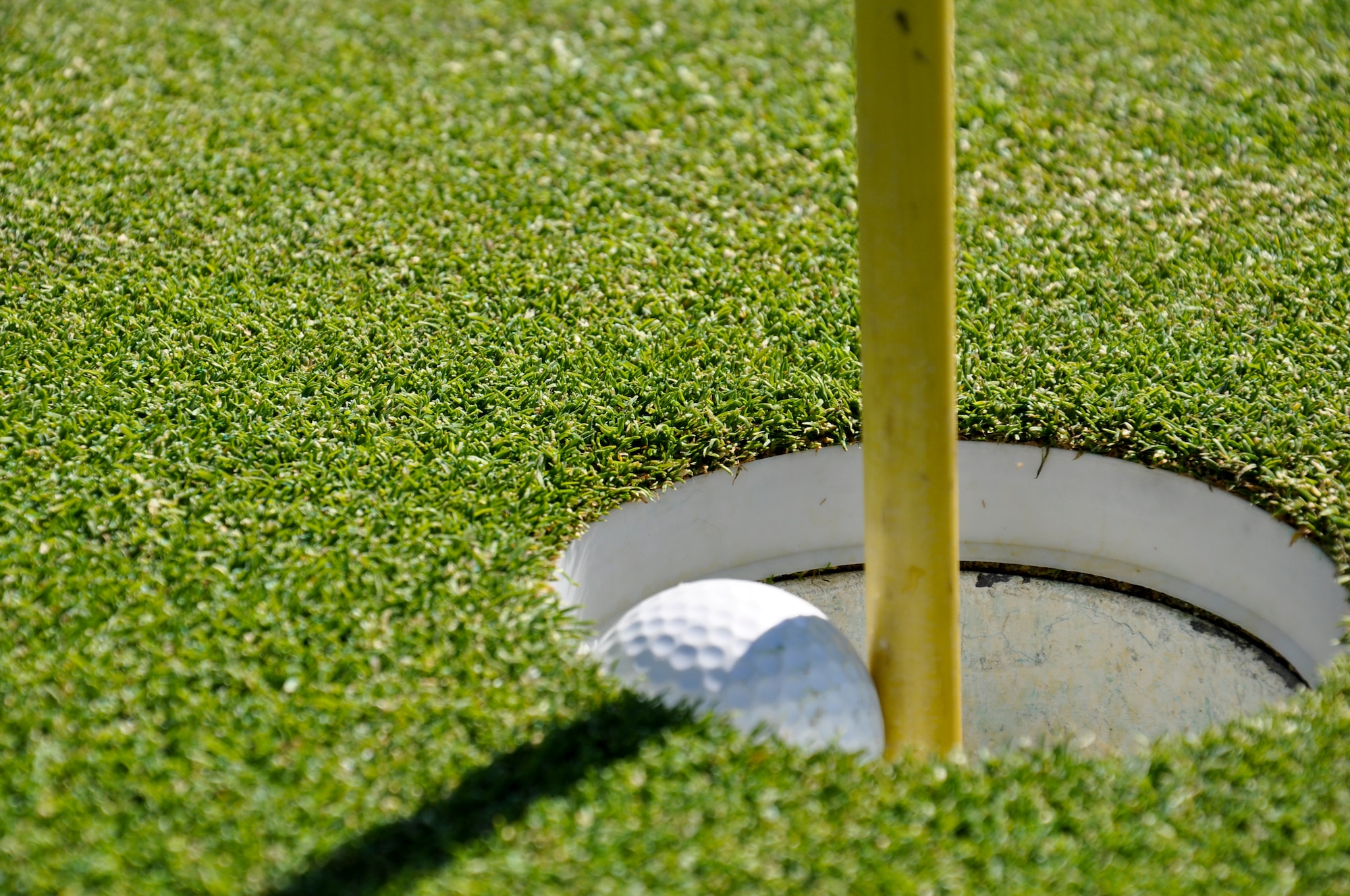 AURORA, Colo. — A golf ball sinks into the cup on the green signaling the end to a practice session at Murphy Creek Golf Course.  The links-style course at Murphy Creek is similar to a course that would be seen in Scotland, according to Chris Manning, a golf-shop associate at the course.  Manning went on to add, “it’s just a great golf course.”  (U.S. Air Force photo by Staff Sgt. Nicholas Rau)