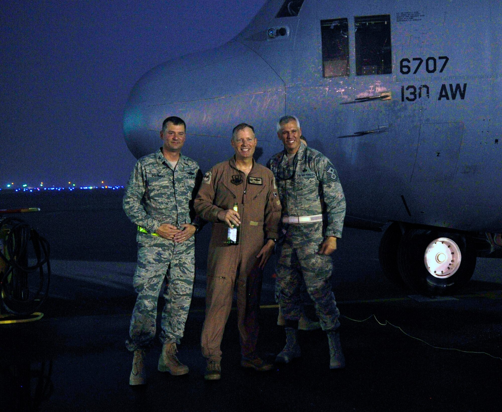 Colonel Mark Polomsky, Col. Michael Zick and Chief Master Sgt. Kenui Balutski celebrate Zick's fini-flight as 386th Air Expeditionary Wing commander. Polomsky is the wing vice commander and Balutski is the wing command chief.