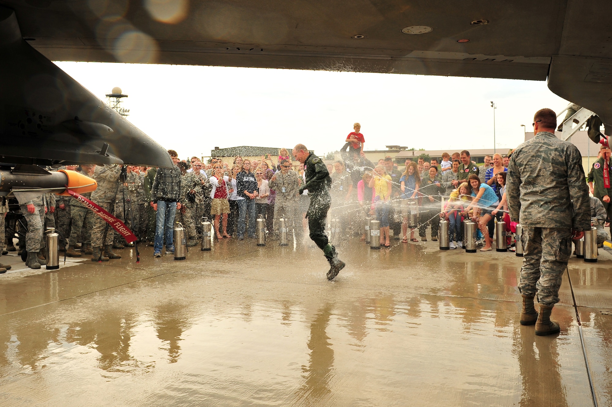 SPANGDAHLEM AIR BASE, Germany – Family, friends and coworkers of Brig. Gen. Chris Weggeman, 52nd Fighter Wing commander, spray water on Weggeman after landing his final flight here June 21. Weggeman commanded the 52nd FW for two years. (U.S. Air Force photo by Airman 1st Class Dillon Davis/Released)