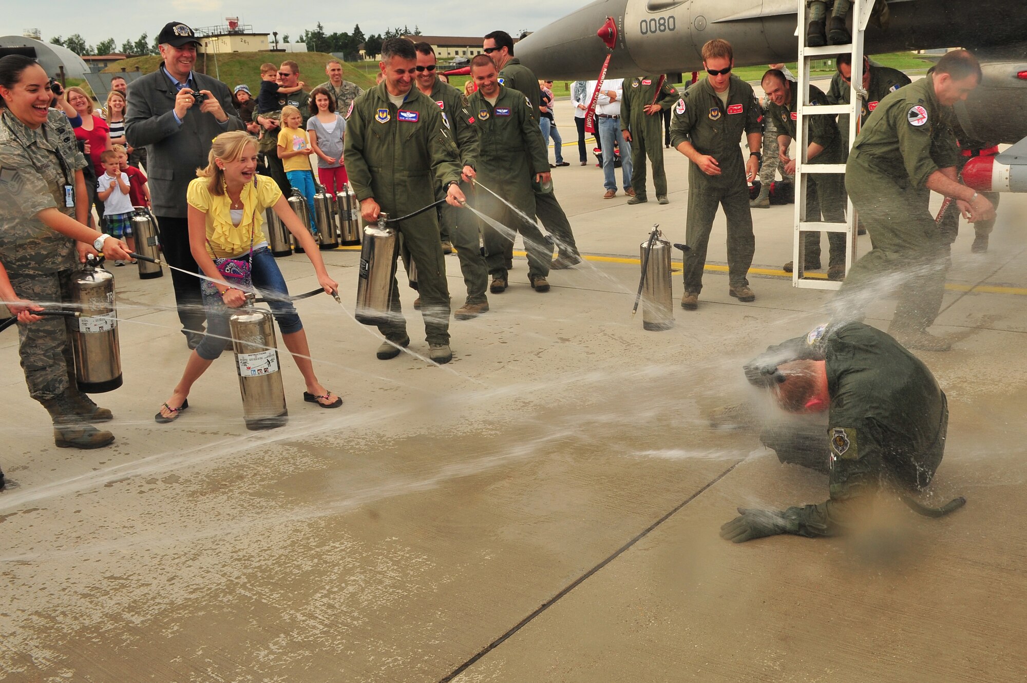 SPANGDAHLEM AIR BASE, Germany – Family, friends and coworkers of Brig. Gen. Chris Weggeman, 52nd Fighter Wing commander, spray water on Weggeman after landing his final flight here June 21. Weggeman commanded the 52nd FW for two years. (U.S. Air Force photo by Airman 1st Class Dillon Davis/Released)