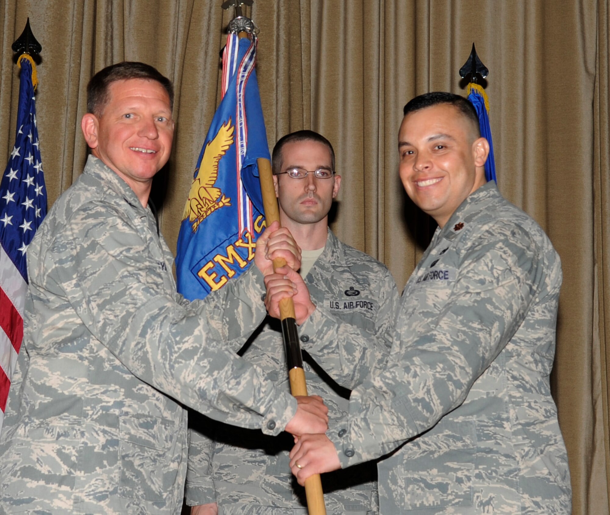 SOUTHWEST ASIA - Col. John Migyanko, 386th Expeditionary Maintenance Group commander, gives the 386th Expeditionary Maintenance Squadron guidon to Maj. Andrew Garcia, during the change of command ceremony here June 24, 2012. (U.S. Air Force photo/Staff Sgt. Alexandra M. Boutte)