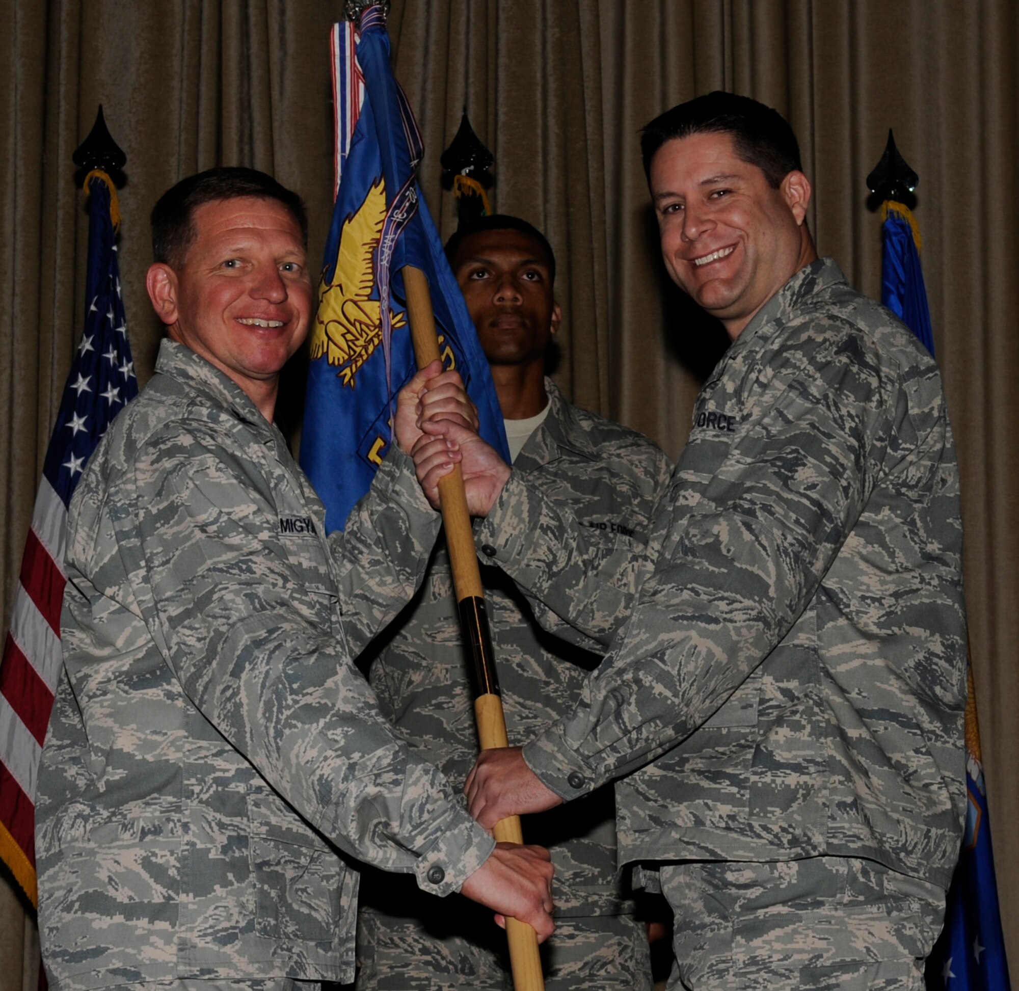 SOUTHWEST ASIA - Col. John Migyanko, 386th Expeditionary Maintenance Group commander, gives the 386th Expeditionary Aircraft Maintenance Squadron guidon to Lt. Col. Robert Gilliland, during the change of command ceremony here June 24, 2012. (U.S. Air Force photo/Staff Sgt. Alexandra M. Boutte)